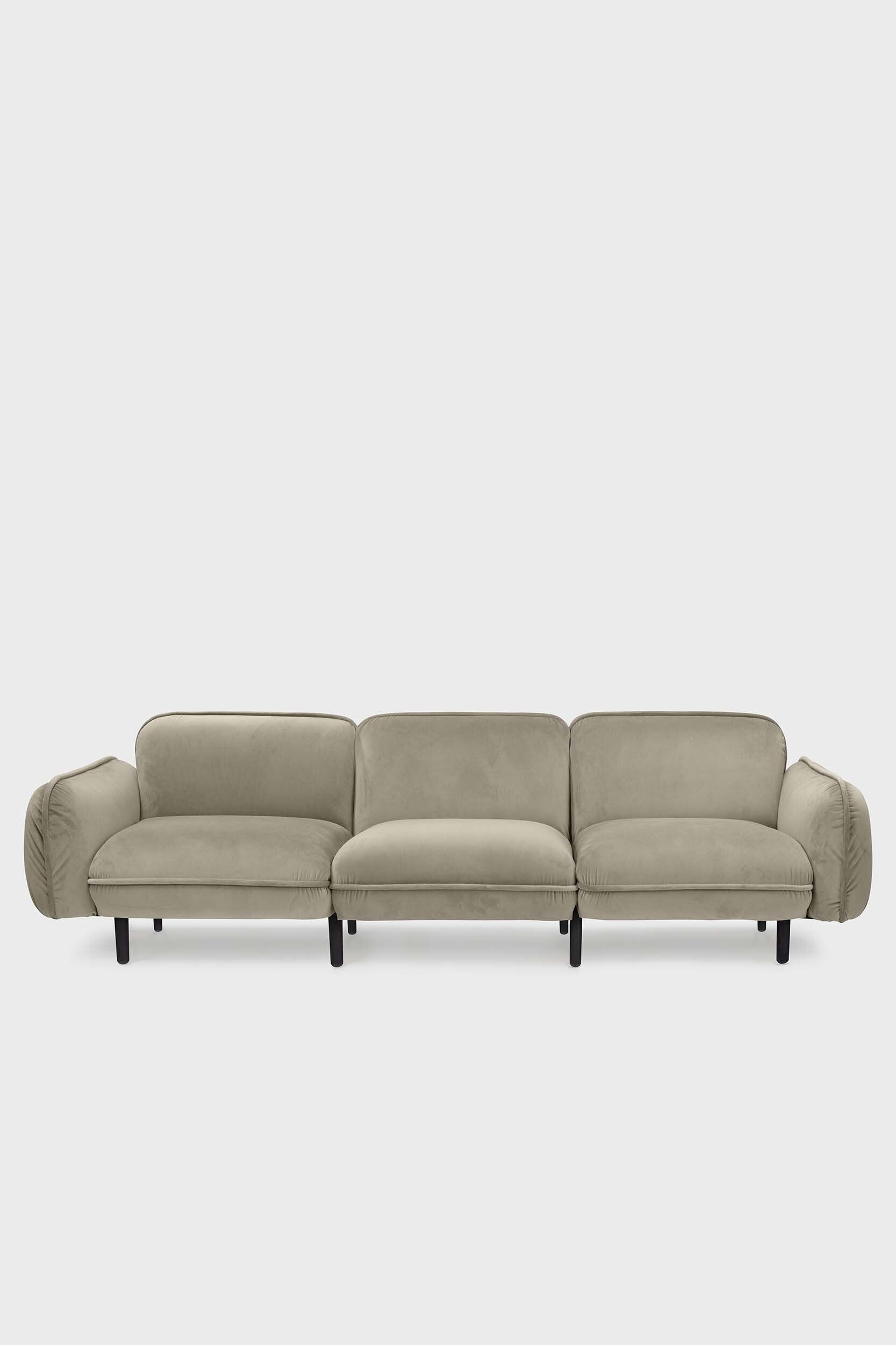 Bean modular sofa with rounded corners, elegant wooden legs, and soft pleated velour fabric in five color options.