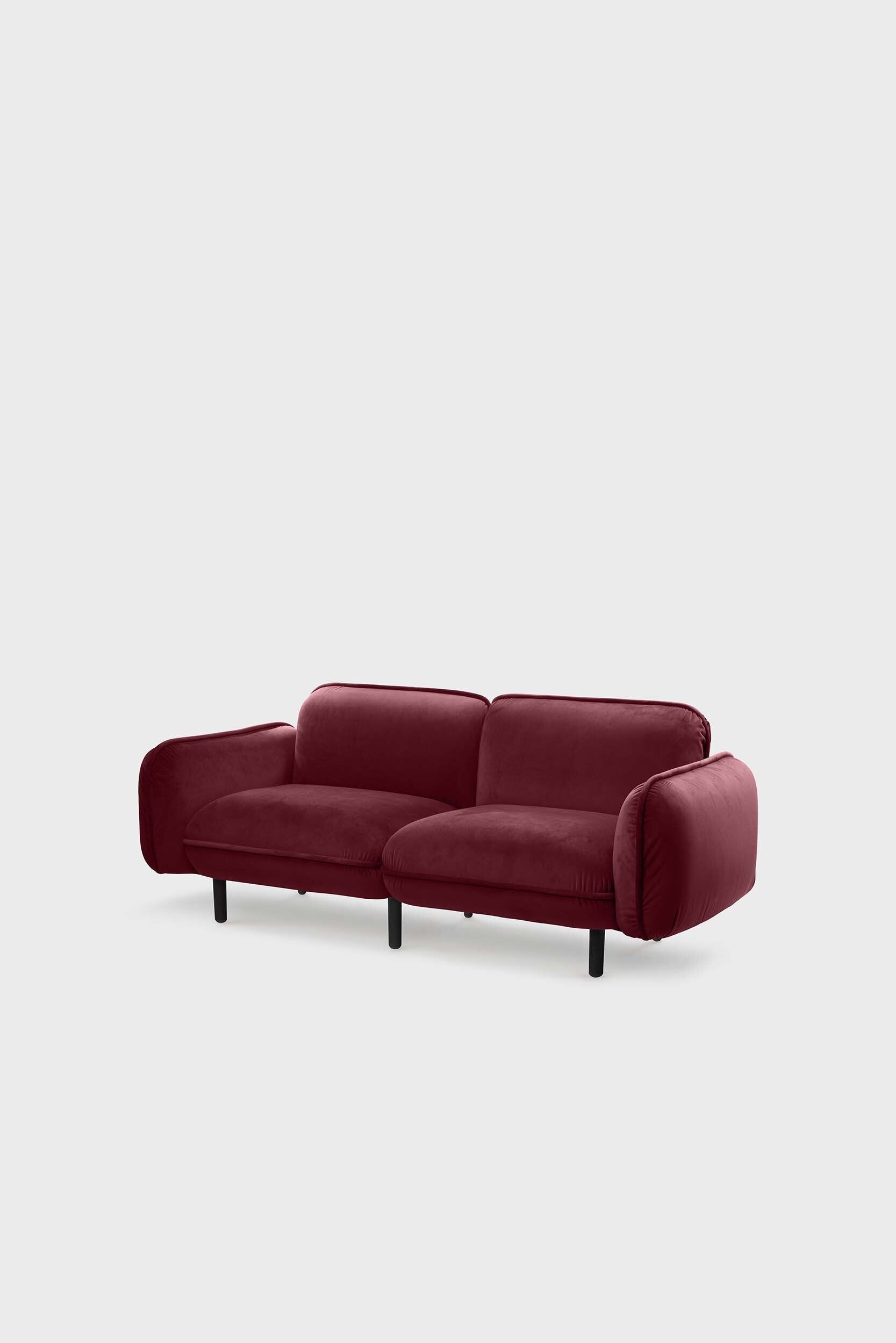 Bean modular sofa with rounded corners, elegant wooden legs, and soft pleated velour fabric in five color options.