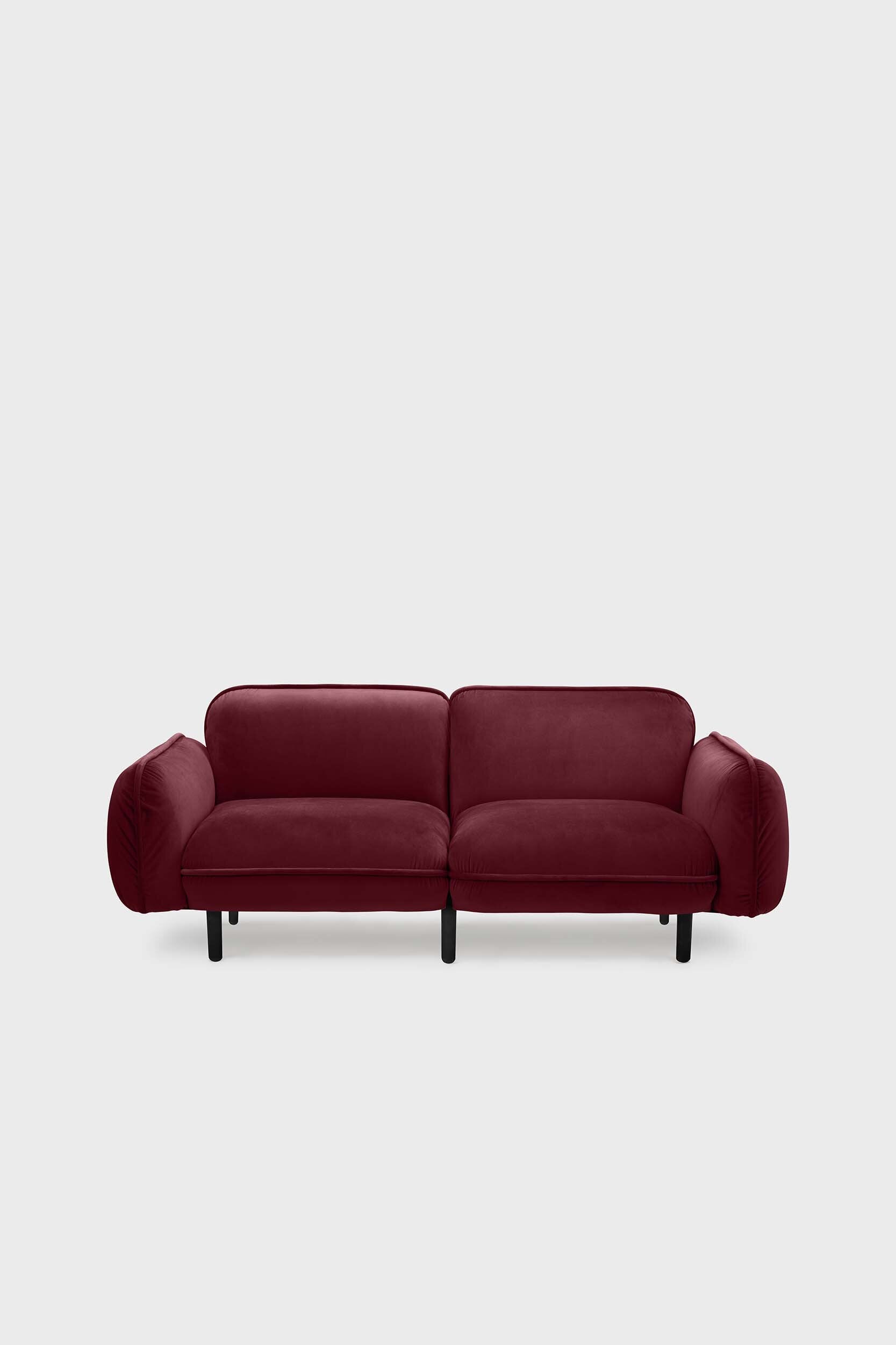 Bean modular sofa with rounded corners, elegant wooden legs, and soft pleated velour fabric in five color options.