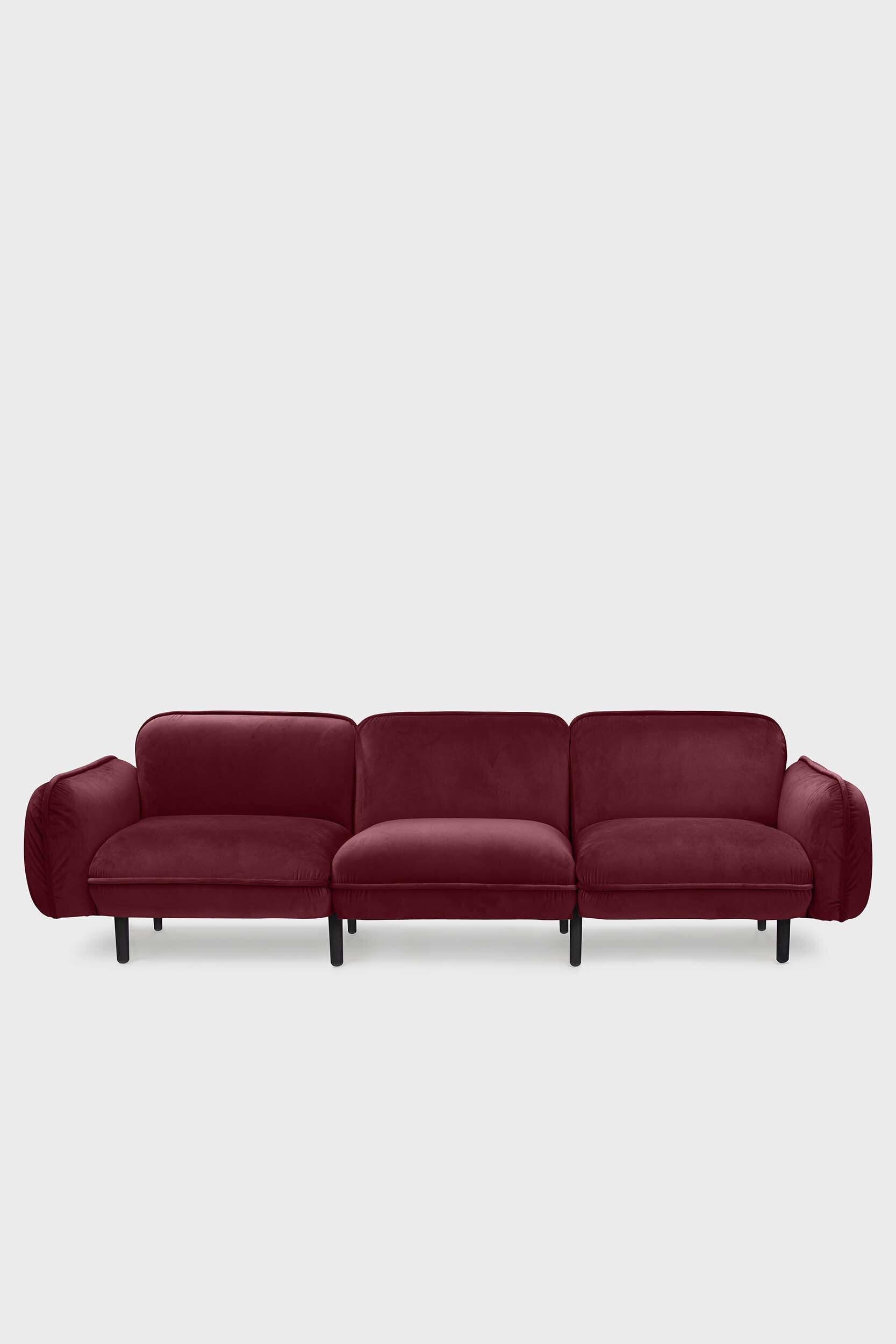 Bean modular sofa with rounded corners, elegant wooden legs, and soft pleated velour fabric in five color options.