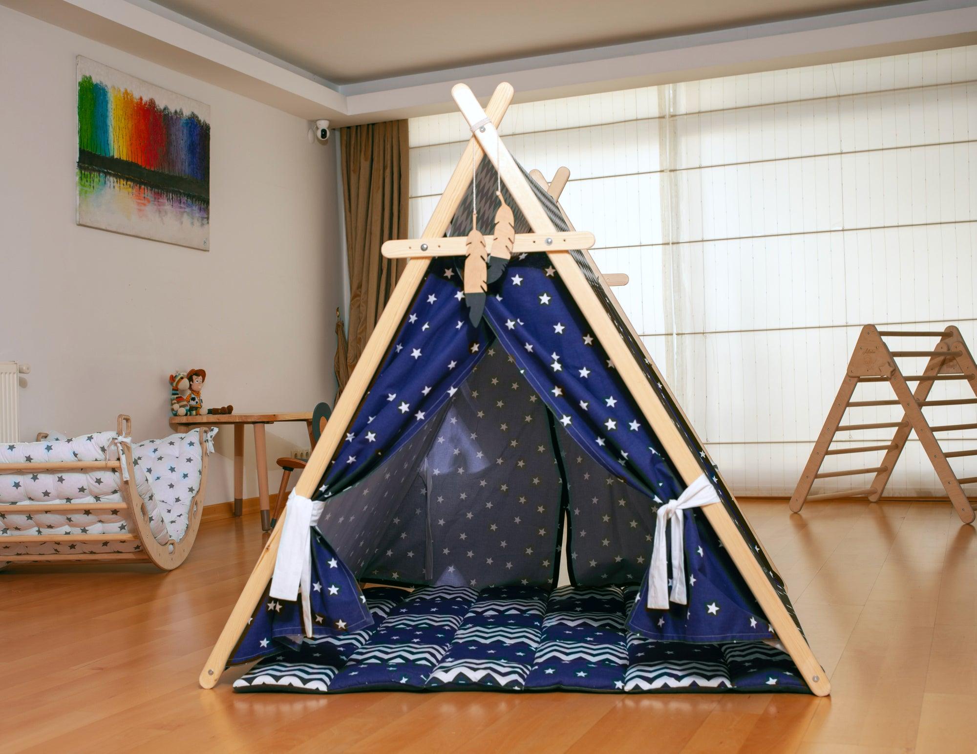 A colorful Blue Stars Play Tent and Play Mat set up in a cozy room, featuring star lights and wooden poles, perfect for children's imaginative play.