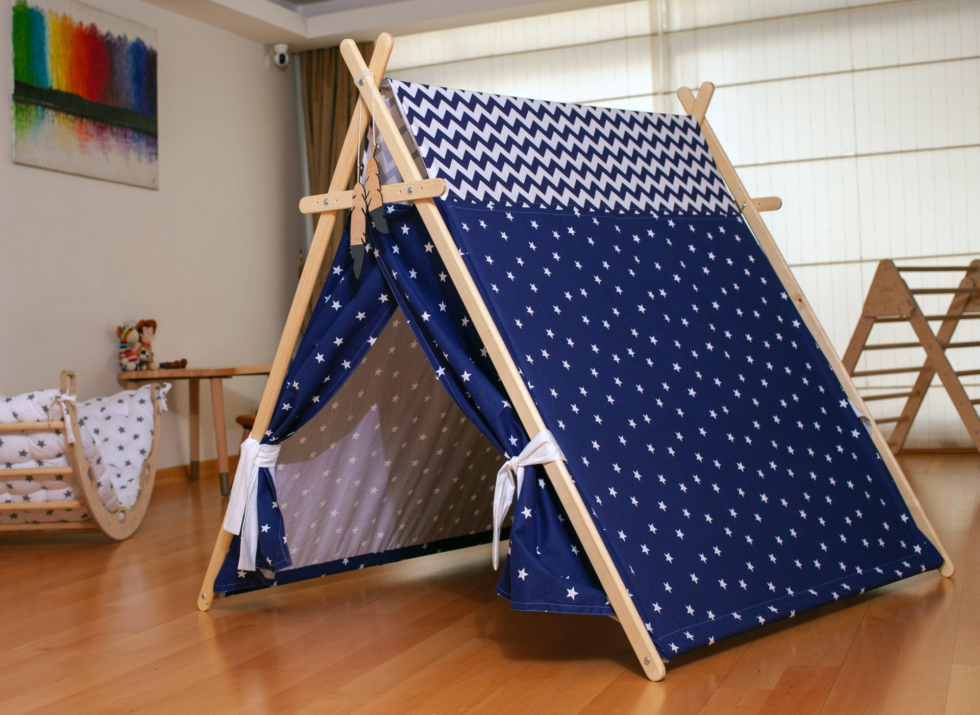 A colorful Blue Stars Play Tent and Play Mat set up in a cozy room, featuring star lights and wooden poles, perfect for children's imaginative play.