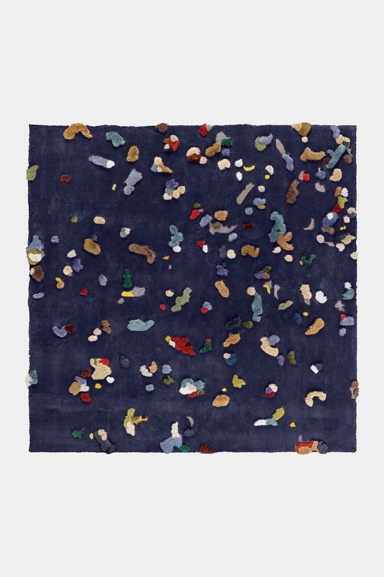 A vibrant Chaos Rug designed by Audronė Drungilaitė, showcasing unique colors and patterns made from leftover yarn, available in dark blue and caramel brown.