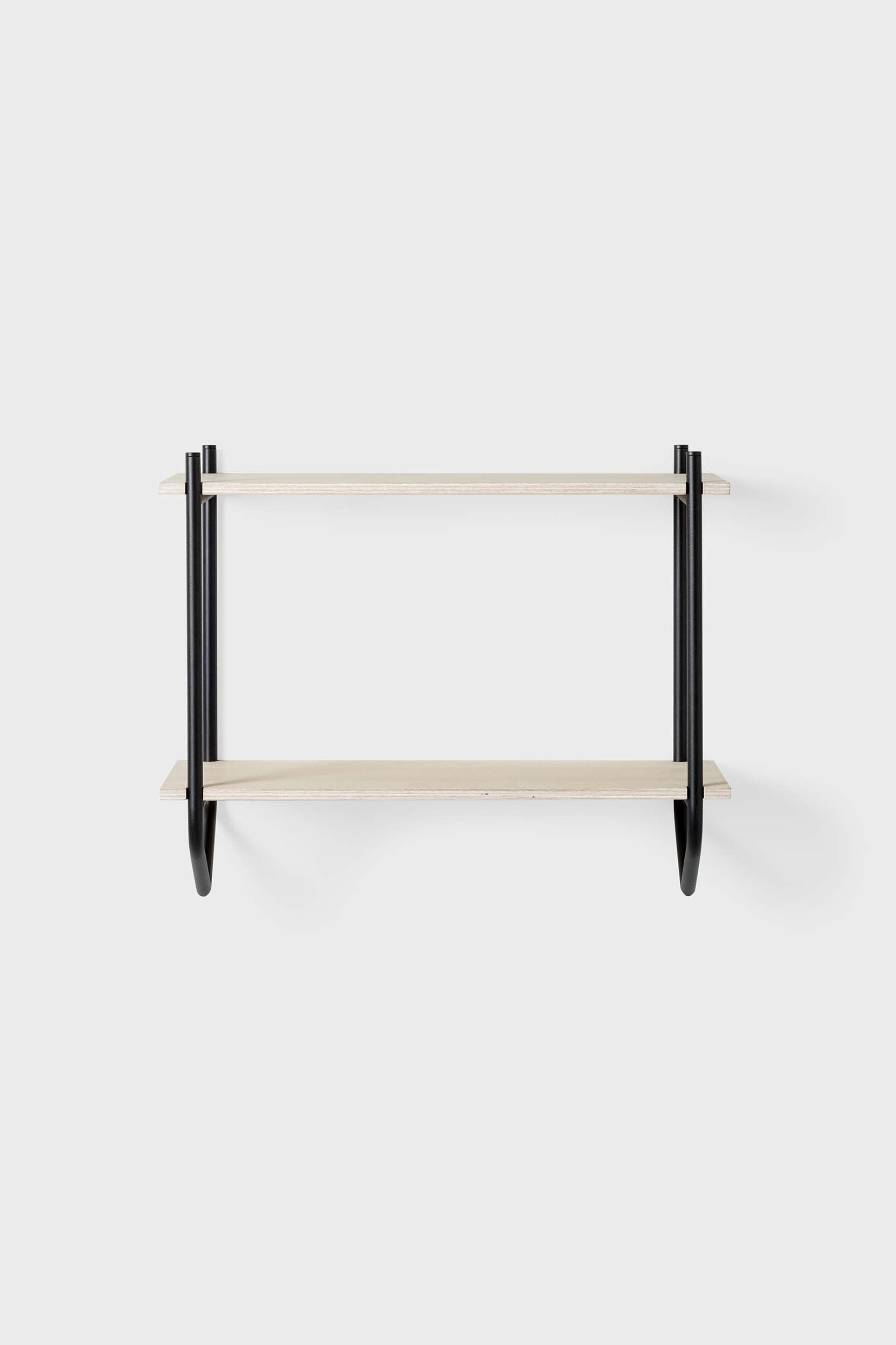 The Dessus Wall Shelf featuring two birch plywood shelves supported by arch metal frames in off white and coal black colors.