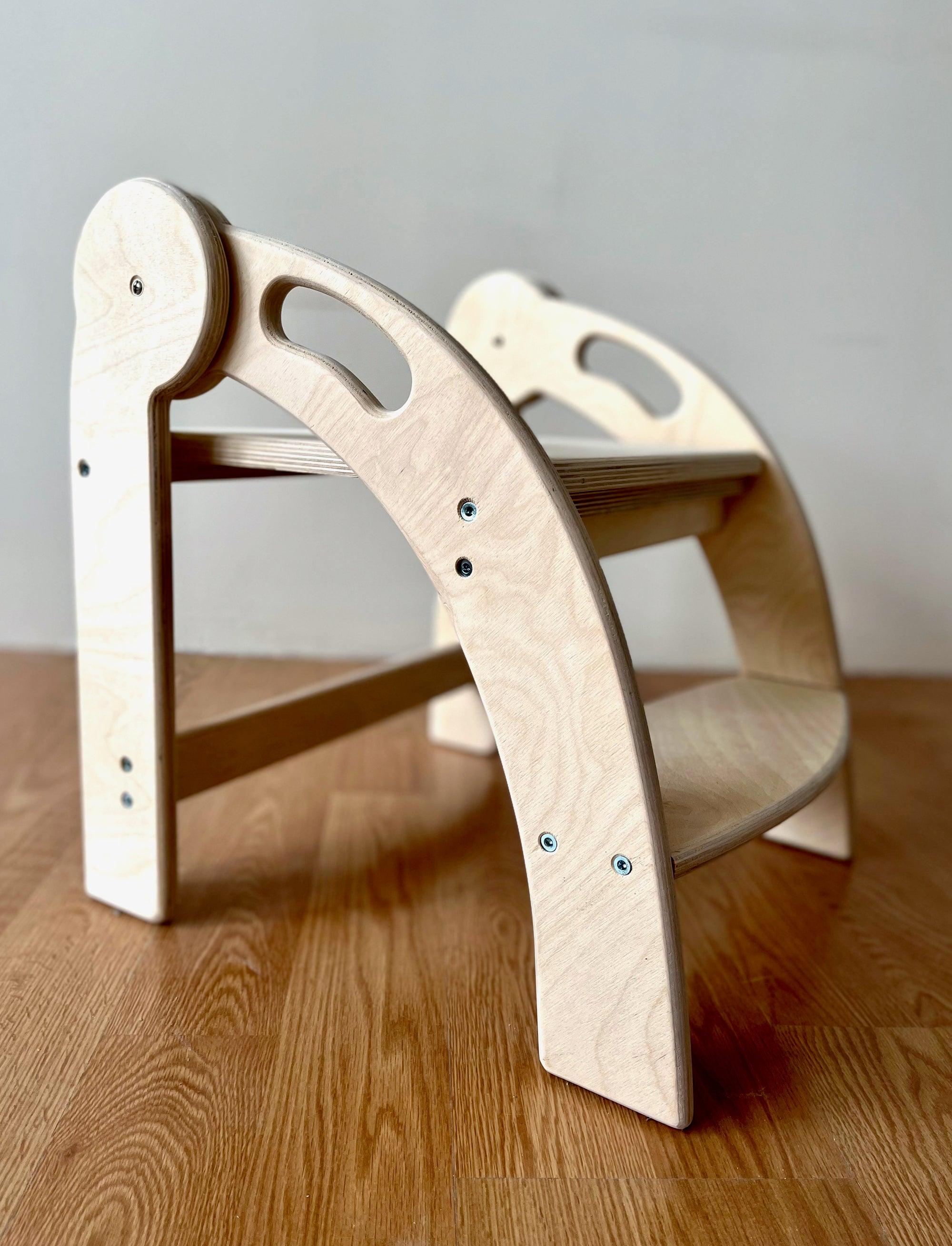 Foldable Montessori Kitchen Step Stool made of natural birch plywood, featuring two steps for children to reach higher surfaces safely.