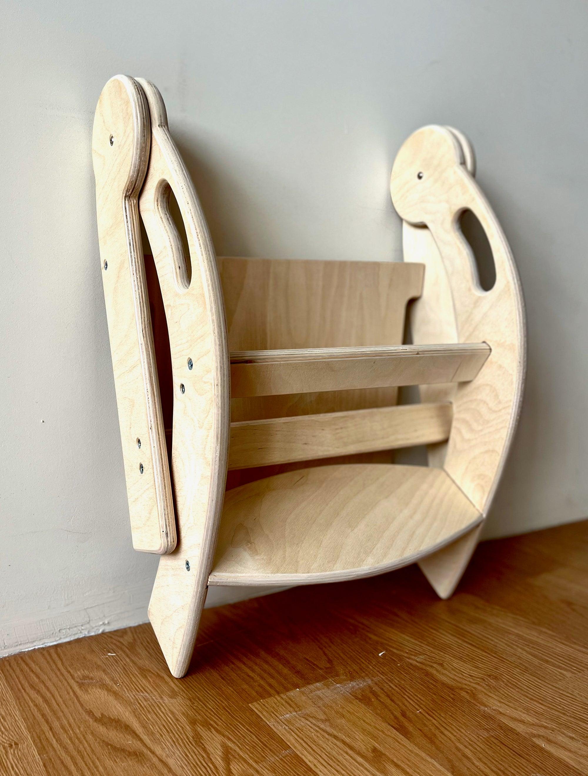 Foldable Montessori Kitchen Step Stool made of natural birch plywood, featuring two steps for children to reach higher surfaces safely.