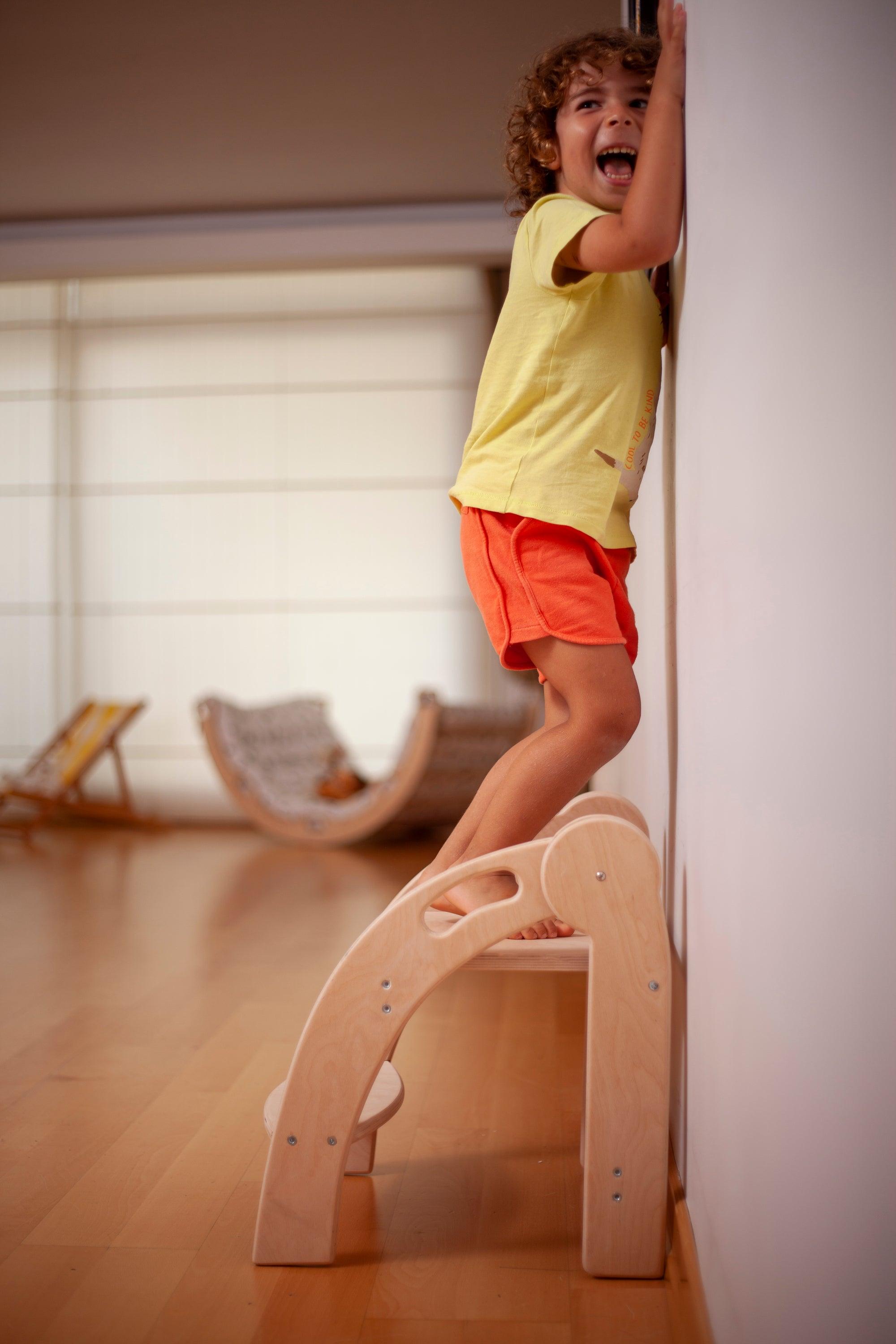 Foldable Montessori Kitchen Step Stool made of natural birch plywood, featuring two steps for children to reach higher surfaces safely.