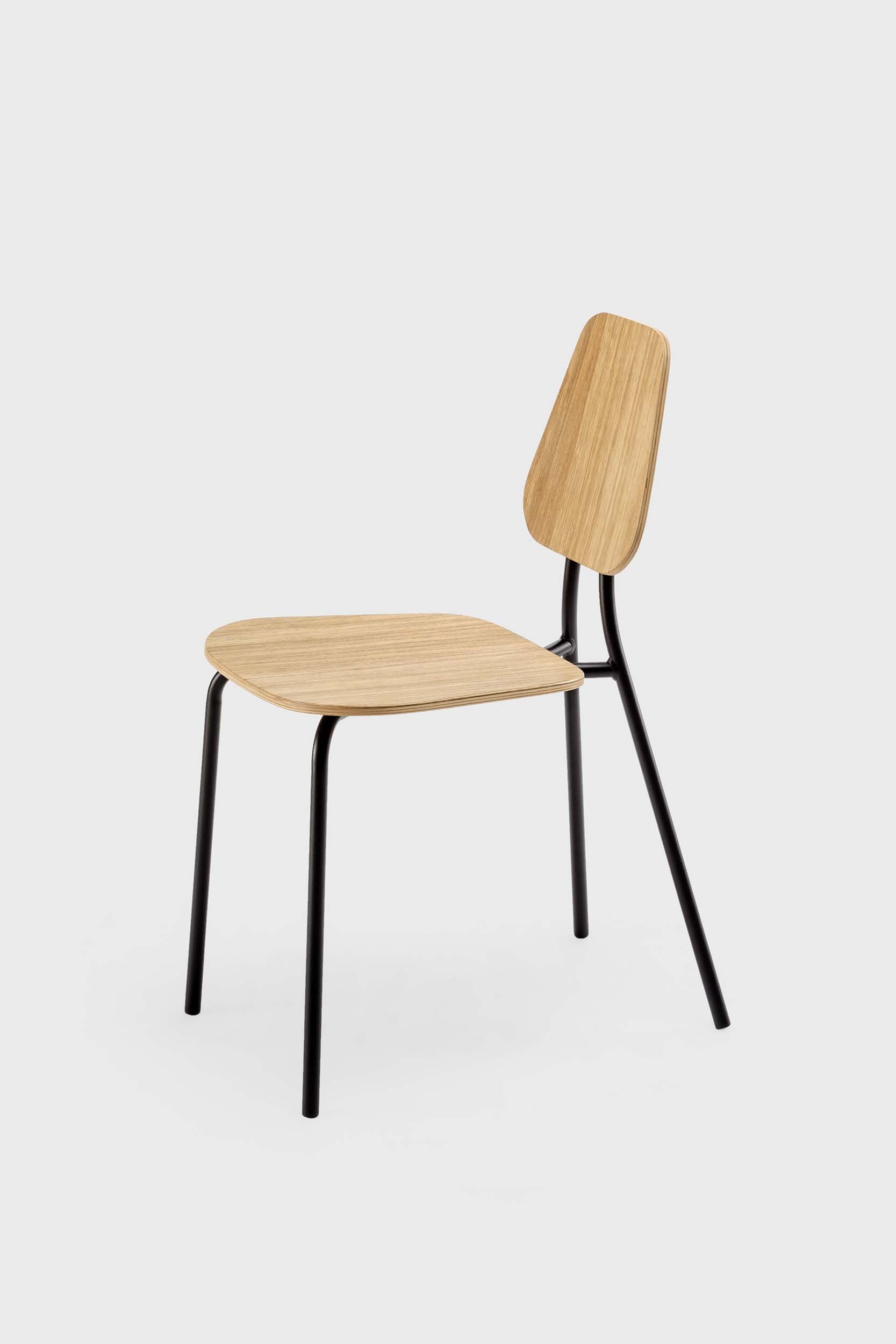 The Hoya Chair features a sleek black metal frame with a veneered plywood seat and backrest, available in natural oil, black, and walnut finishes, showcasing its modern design.