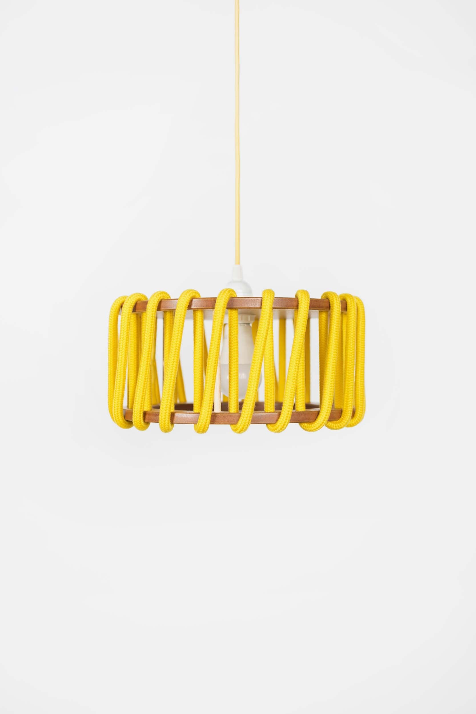 Stylish Macaron Pendant Lamp designed by Silvia Ceñal, featuring wooden elements and a textured cord, perfect for modern interiors.