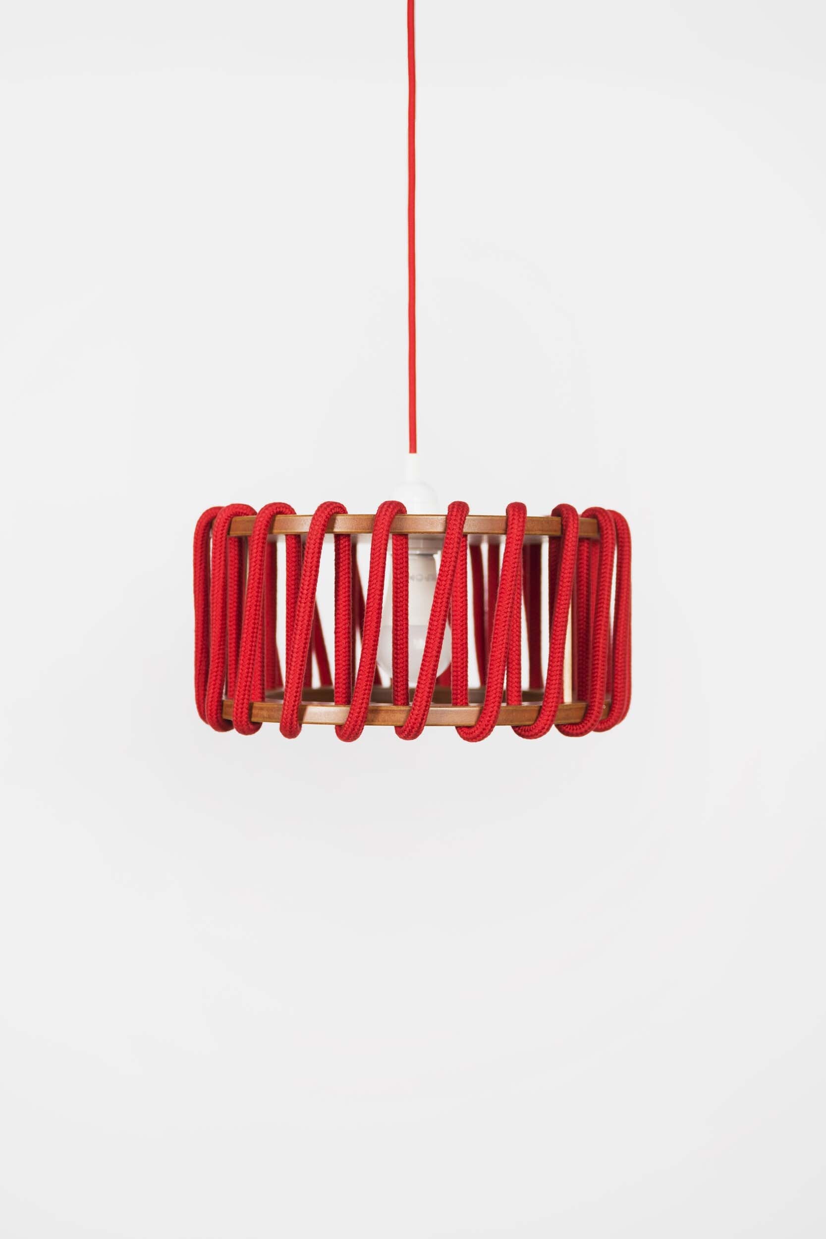 Stylish Macaron Pendant Lamp designed by Silvia Ceñal, featuring wooden elements and a textured cord, perfect for modern interiors.