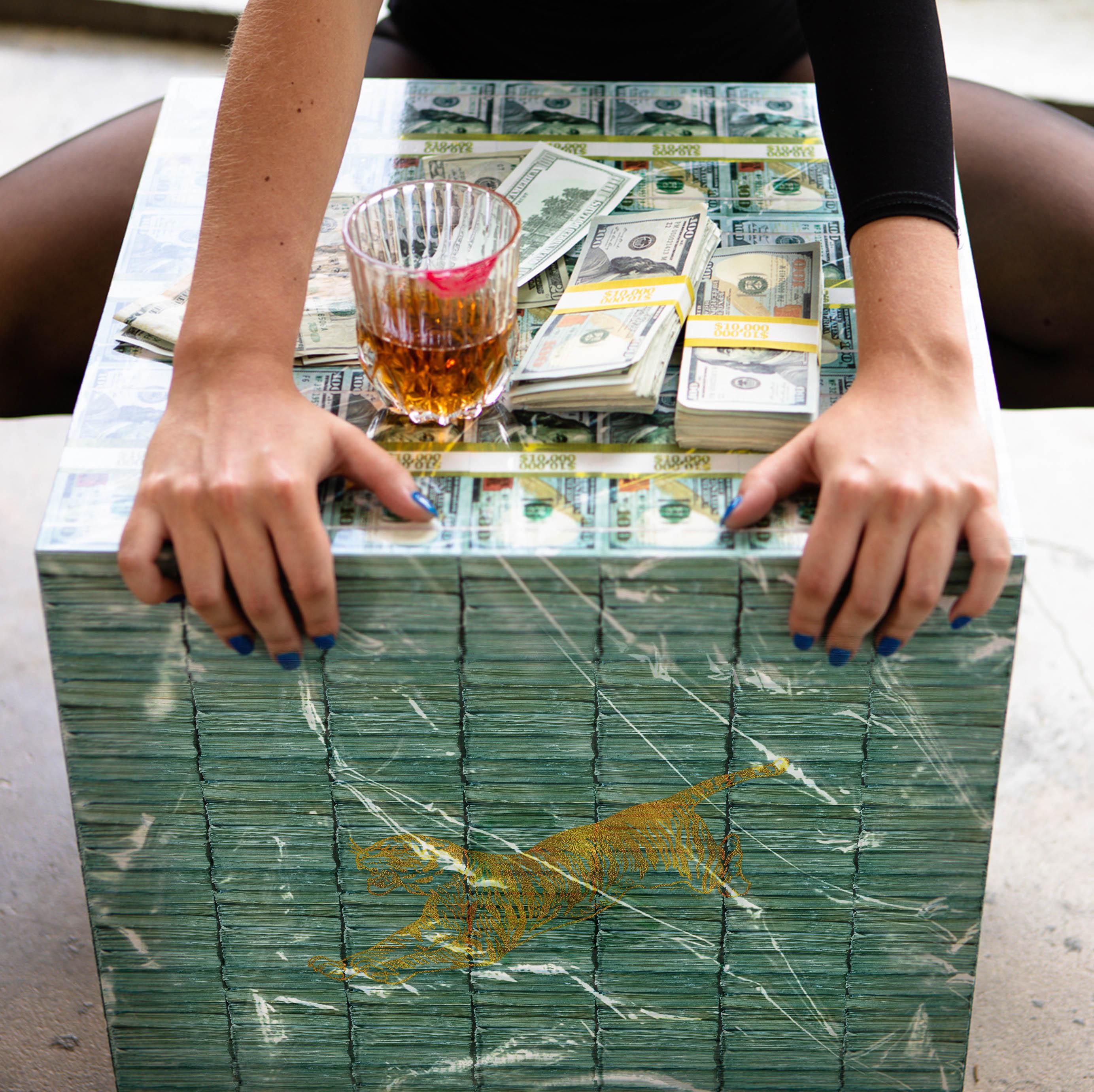 Million Dollar Cube Table Series F with high gloss finish, featuring a stylish design and a $10,000 prop money stack.