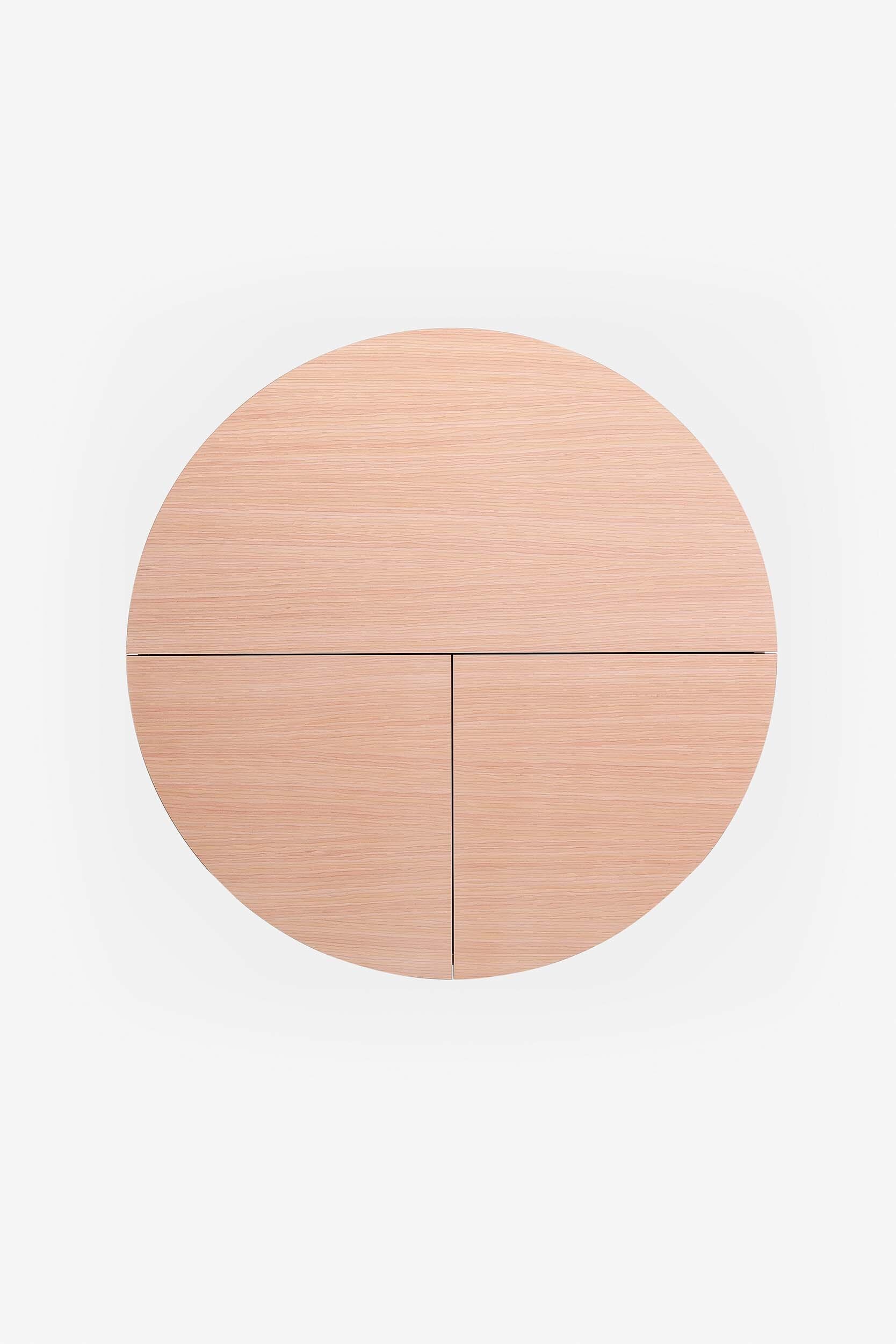 A sleek, round wall-mounted cabinet that transforms into a workspace, dressing table, or bar, featuring adjustable height and customizable shelving.