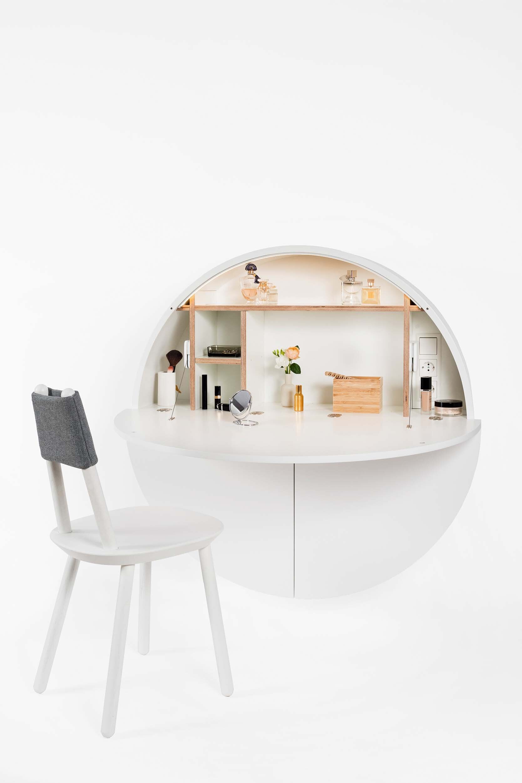 A sleek, round wall-mounted cabinet that transforms into a workspace, dressing table, or bar, featuring adjustable height and customizable shelving.