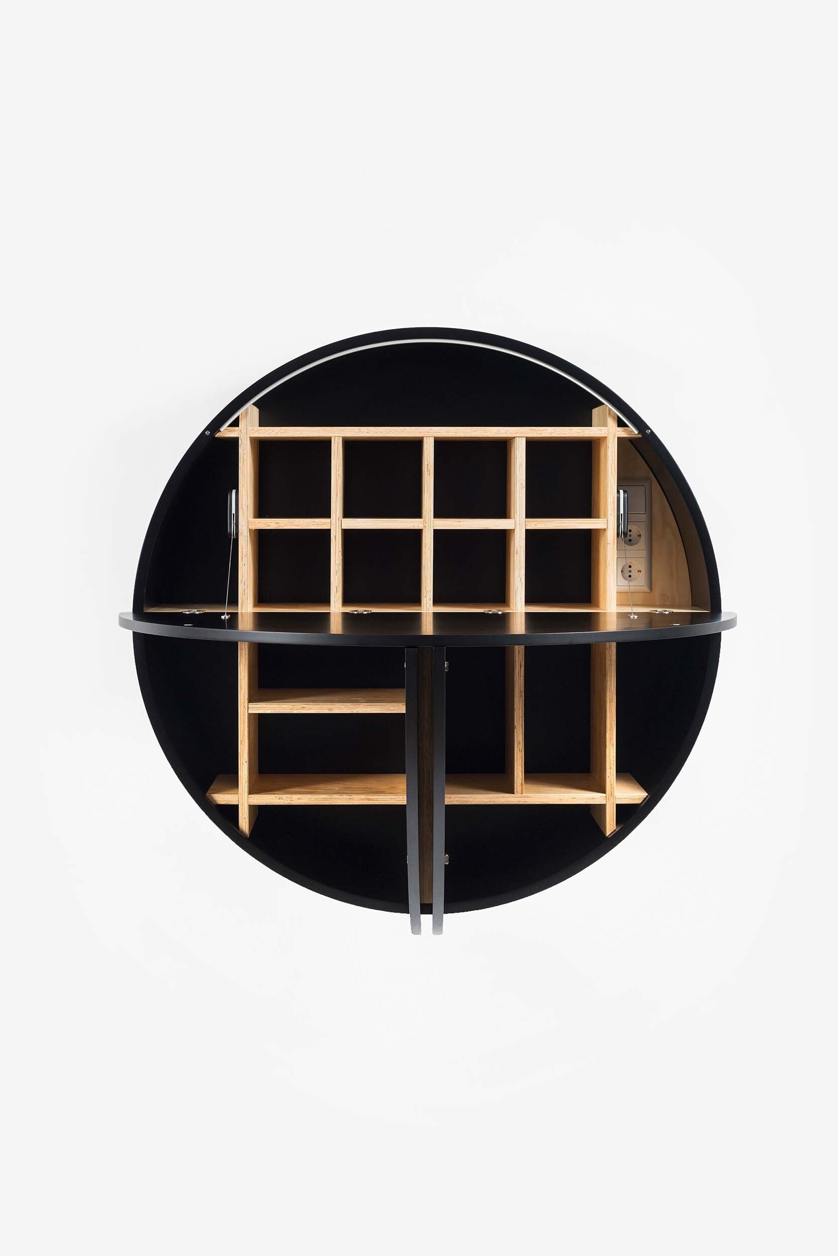 A sleek, round wall-mounted cabinet that transforms into a workspace, dressing table, or bar, featuring adjustable height and customizable shelving.