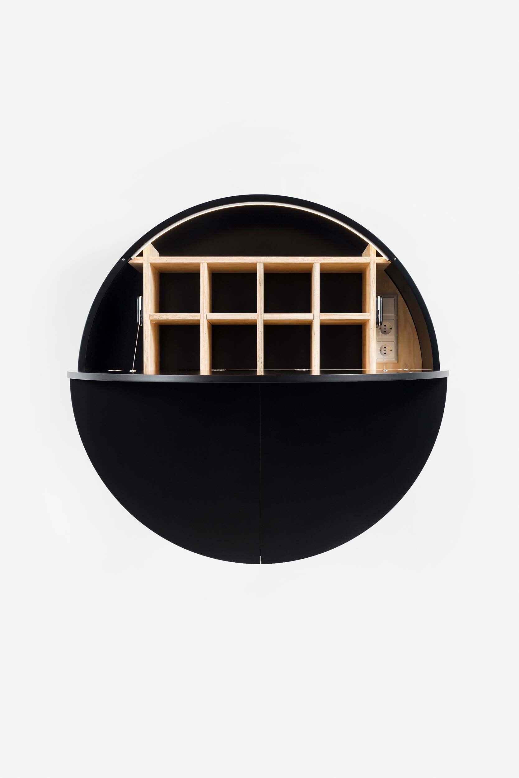 A sleek, round wall-mounted cabinet that transforms into a workspace, dressing table, or bar, featuring adjustable height and customizable shelving.