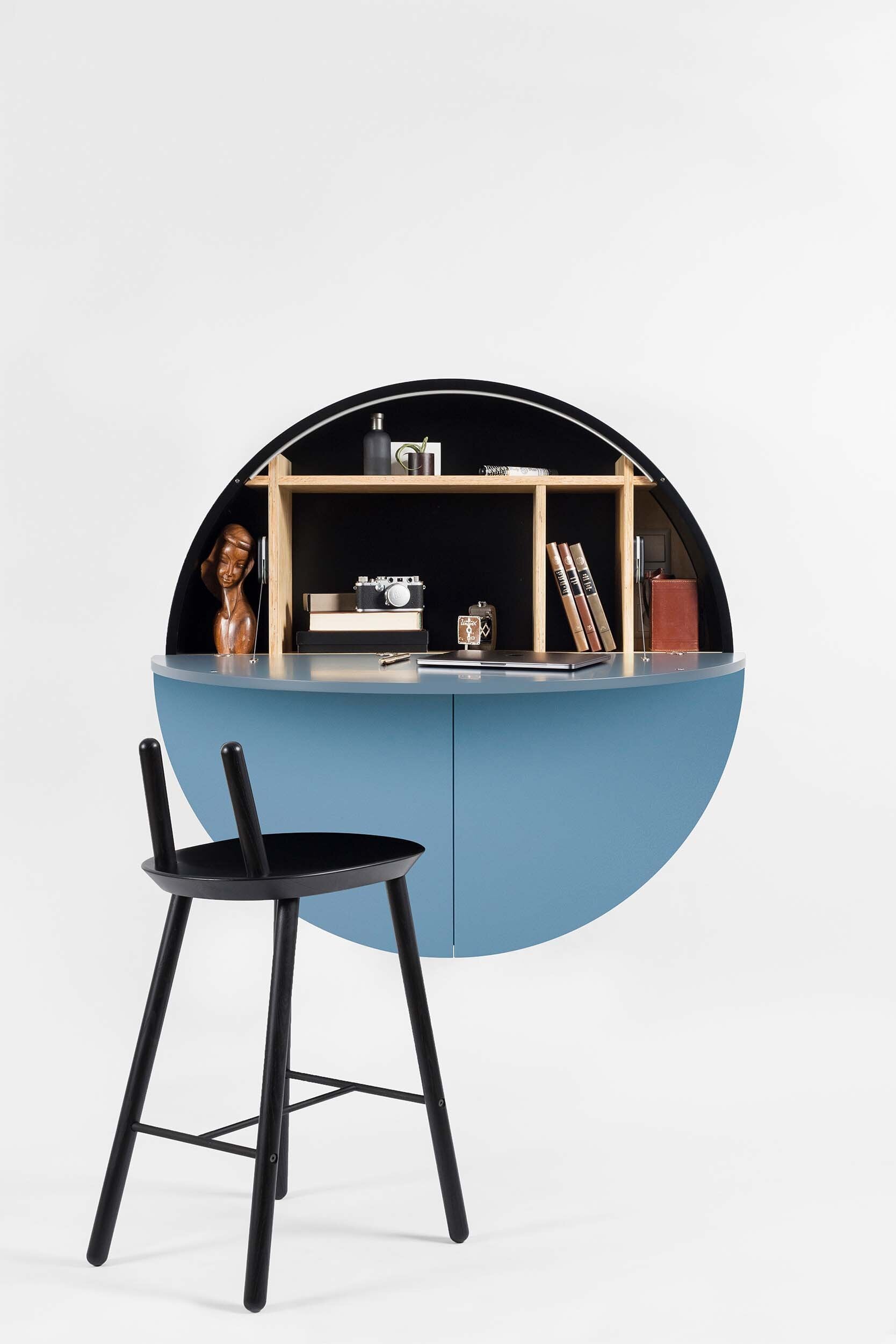 A sleek, round wall-mounted cabinet that transforms into a workspace, dressing table, or bar, featuring adjustable height and customizable shelving.