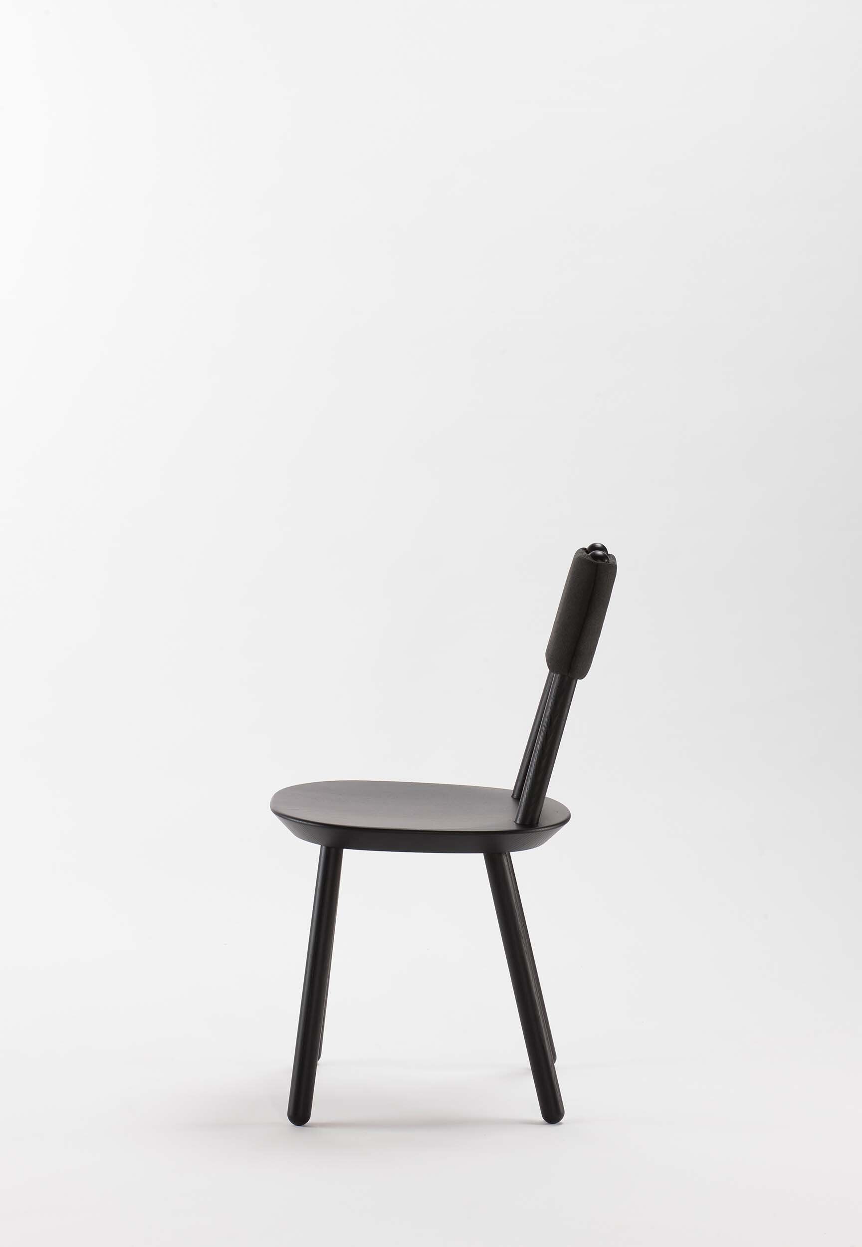 Naïve Dining Chair featuring a minimalist design with a solid ash seat and six equal-length legs, showcasing its playful and ergonomic structure.