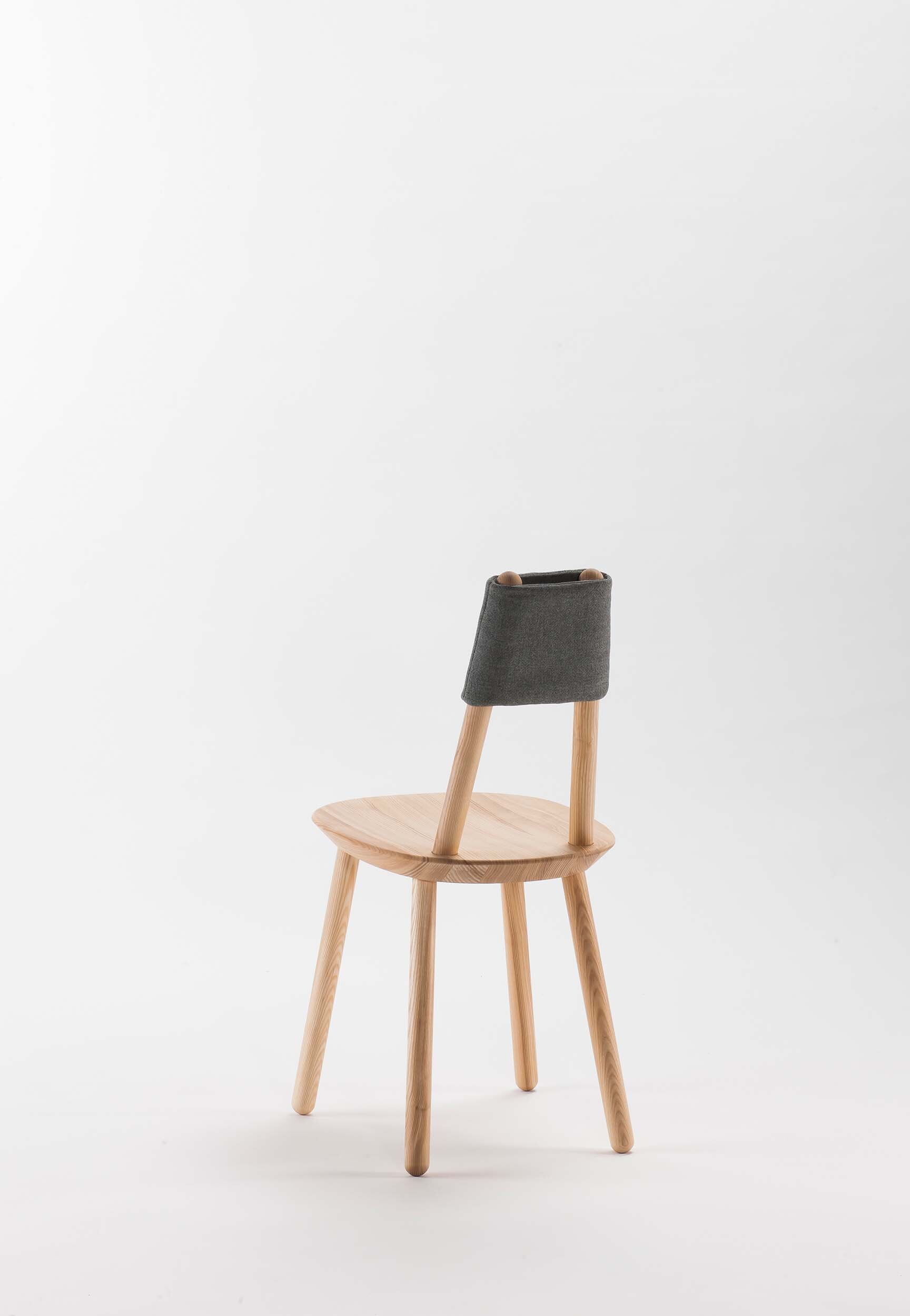 Naïve Dining Chair featuring a minimalist design with a solid ash seat and six equal-length legs, showcasing its playful and ergonomic structure.