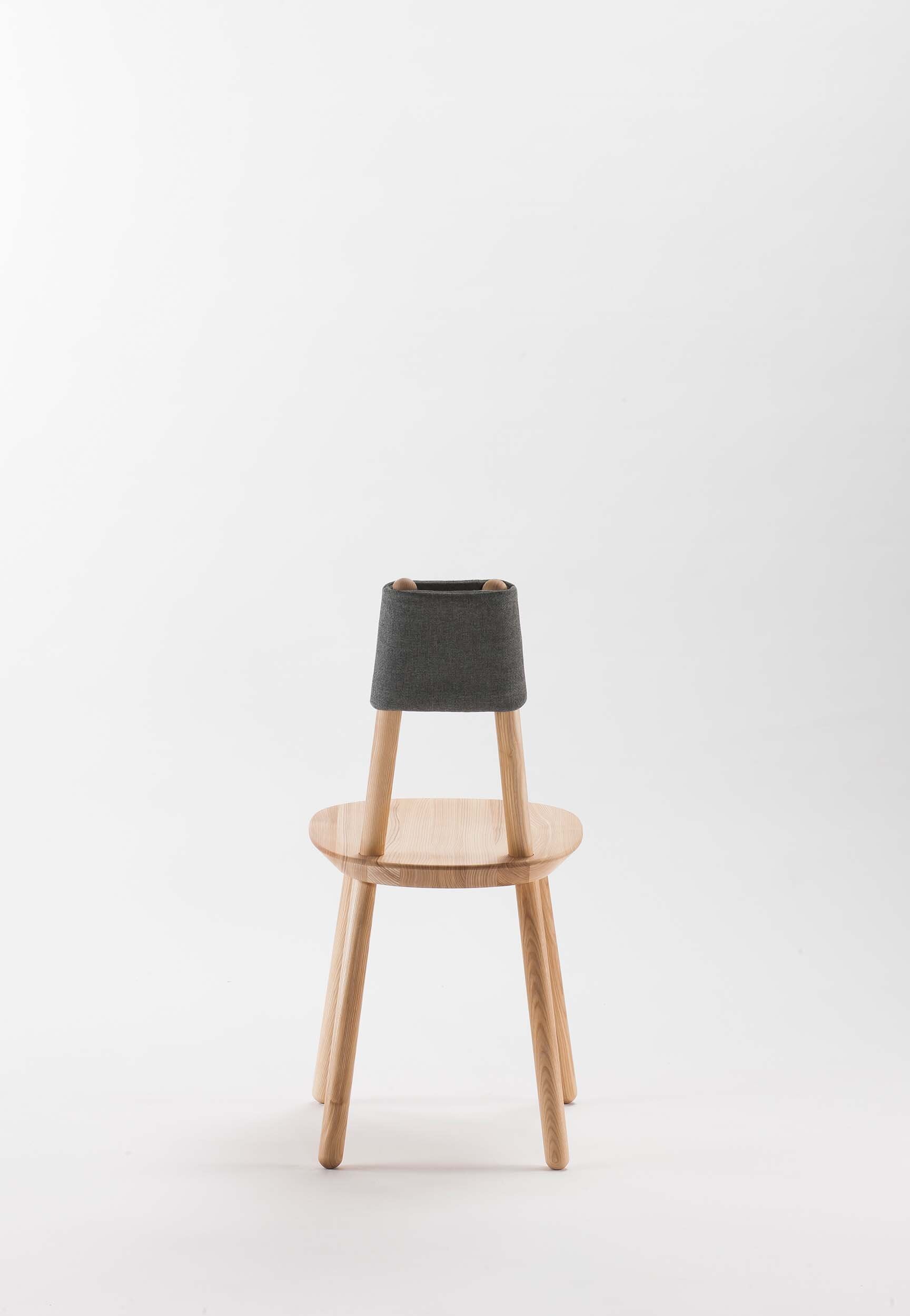 Naïve Dining Chair featuring a minimalist design with a solid ash seat and six equal-length legs, showcasing its playful and ergonomic structure.