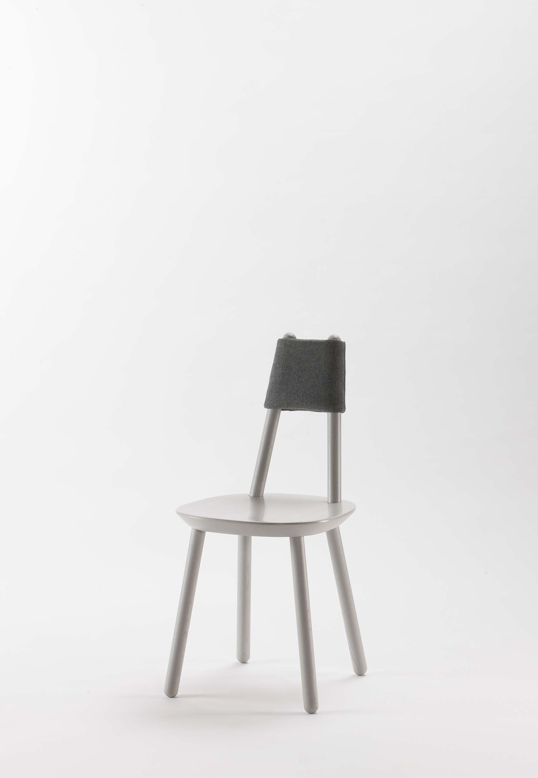 Naïve Dining Chair featuring a minimalist design with a solid ash seat and six equal-length legs, showcasing its playful and ergonomic structure.