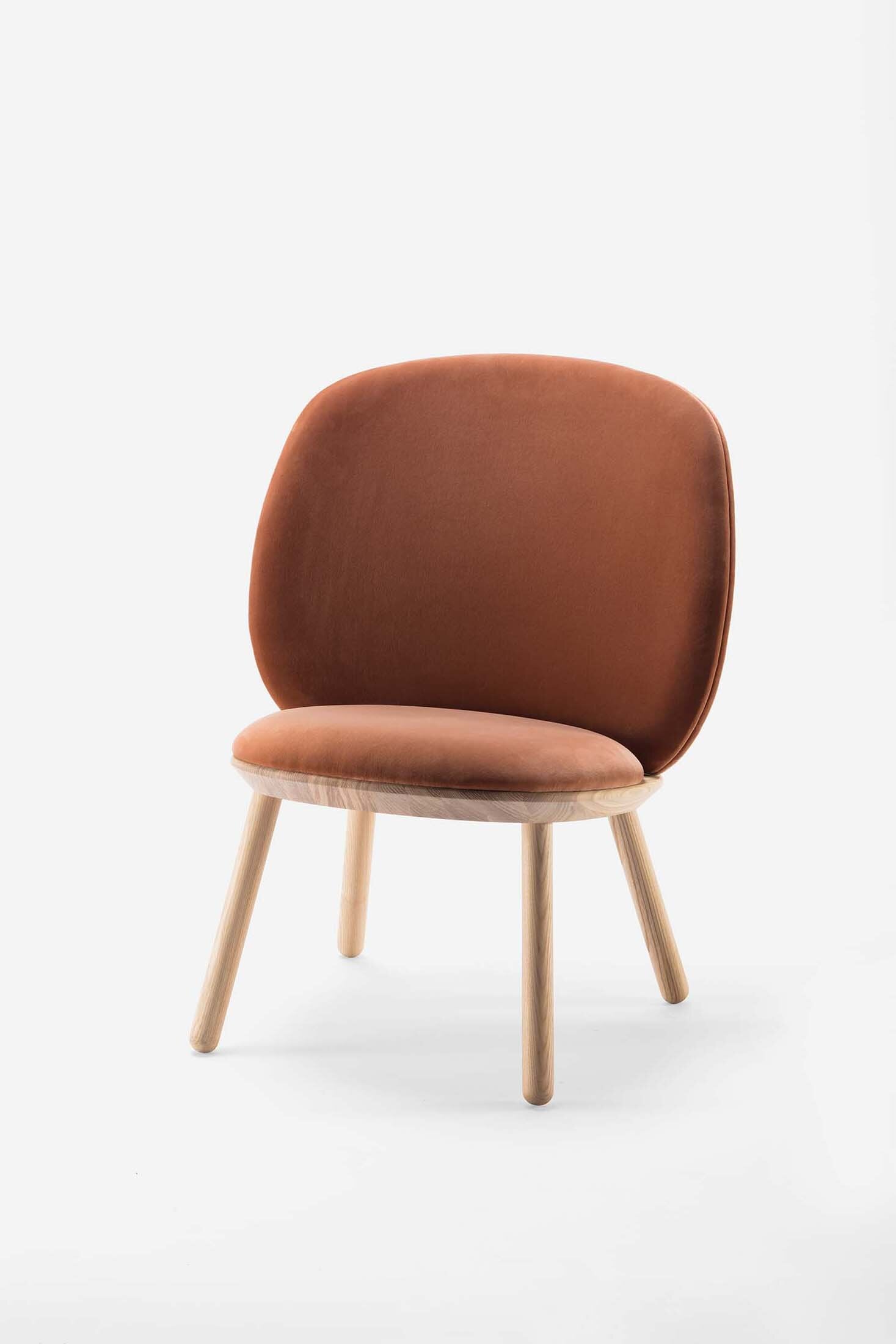 Naïve Low Chair featuring a large leather strap, wooden body, and textile upholstery, designed for comfort and style.