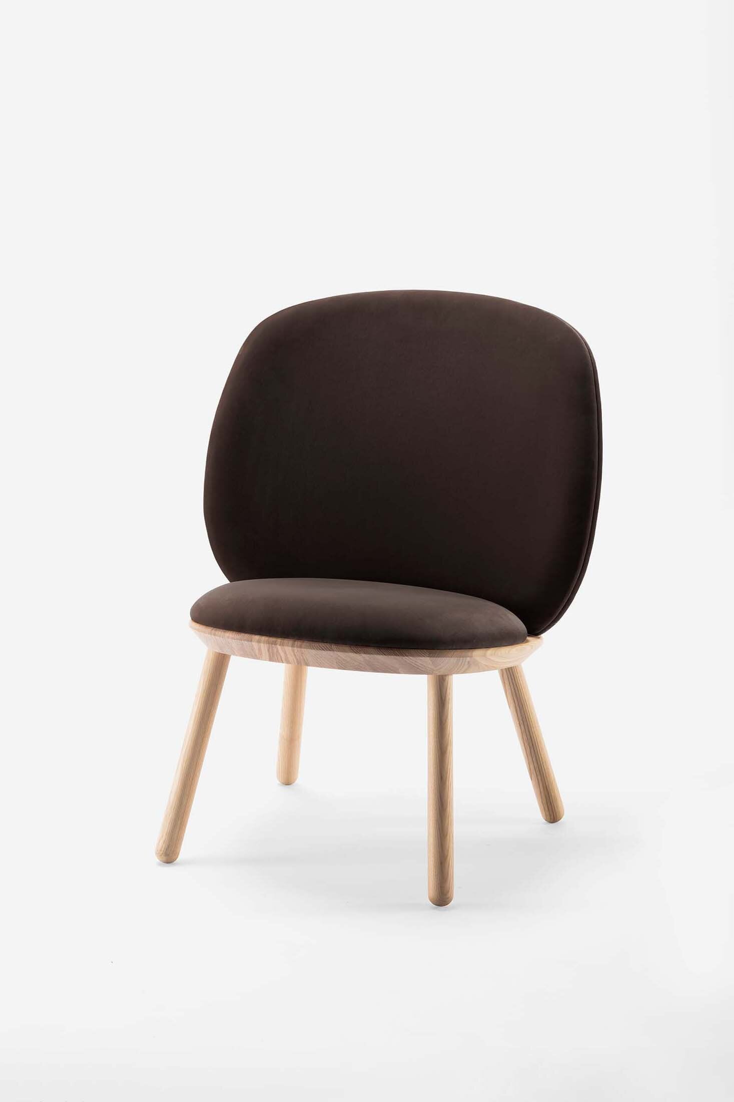 Naïve Low Chair featuring a large leather strap, wooden body, and textile upholstery, designed for comfort and style.