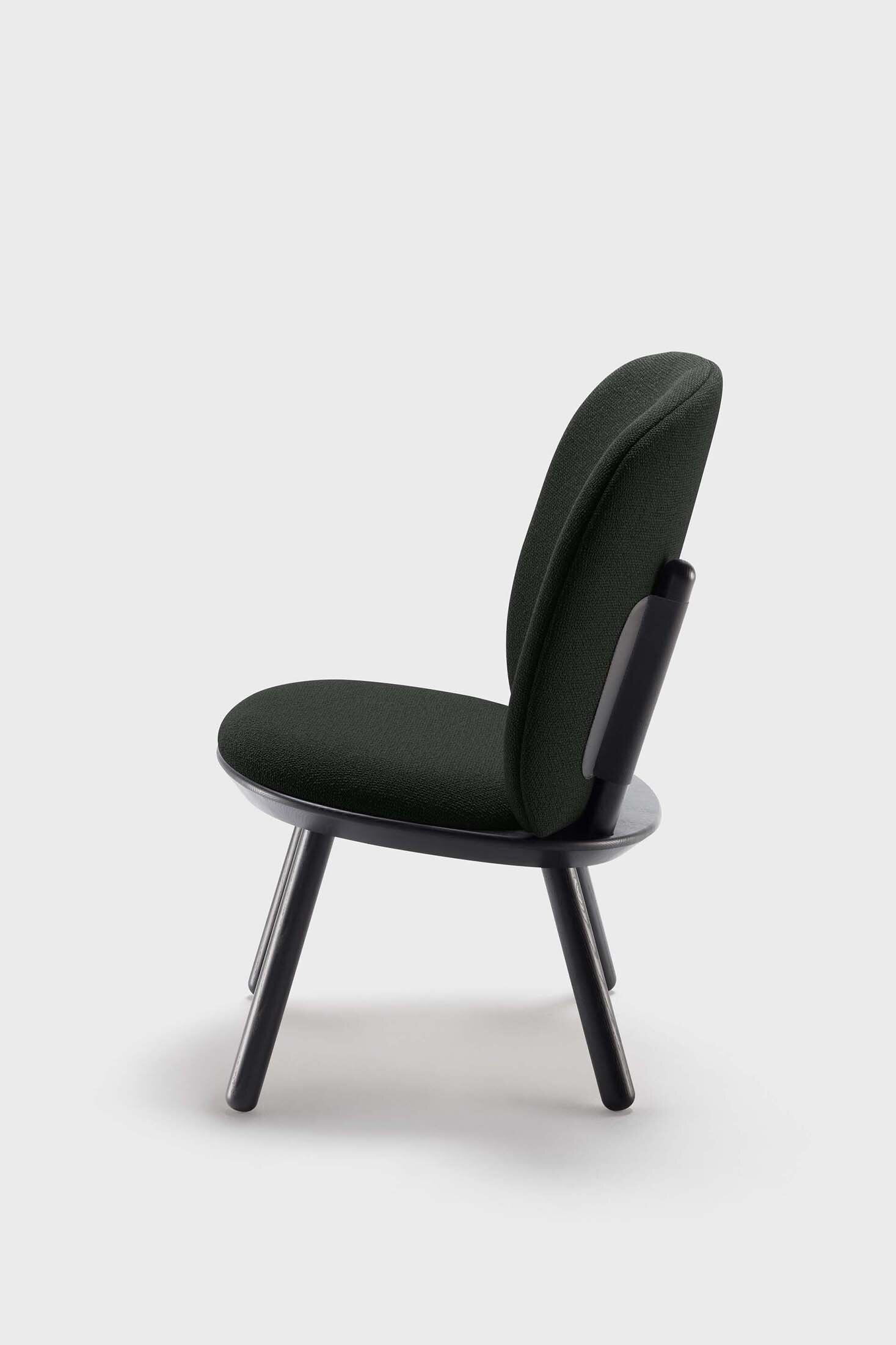 Naïve Low Chair featuring a large leather strap, wooden body, and textile upholstery, designed for comfort and style.