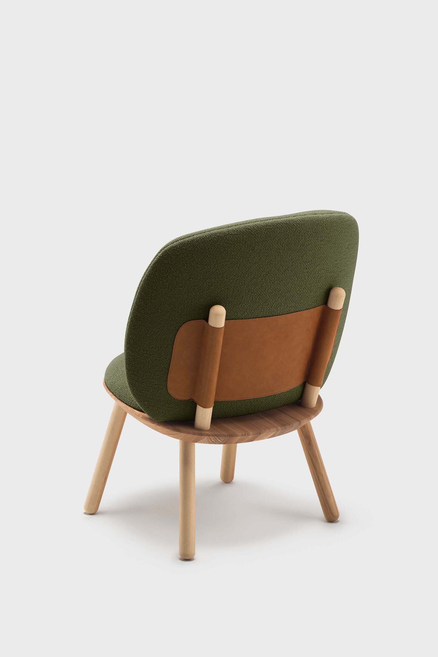 Naïve Low Chair featuring a large leather strap, wooden body, and textile upholstery, designed for comfort and style.