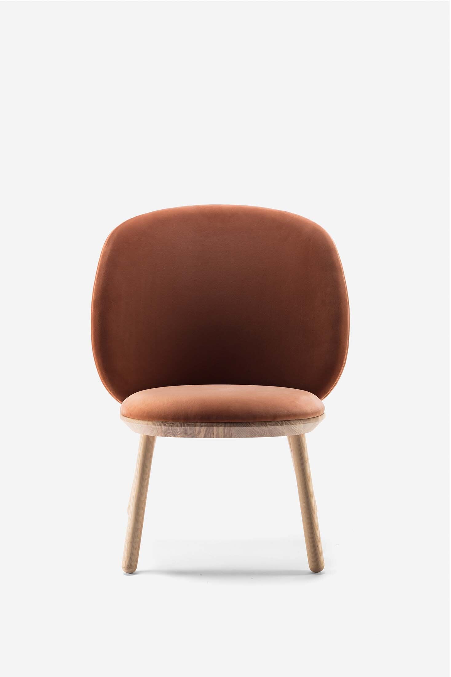 Naïve Low Chair featuring a large leather strap, wooden body, and textile upholstery, designed for comfort and style.