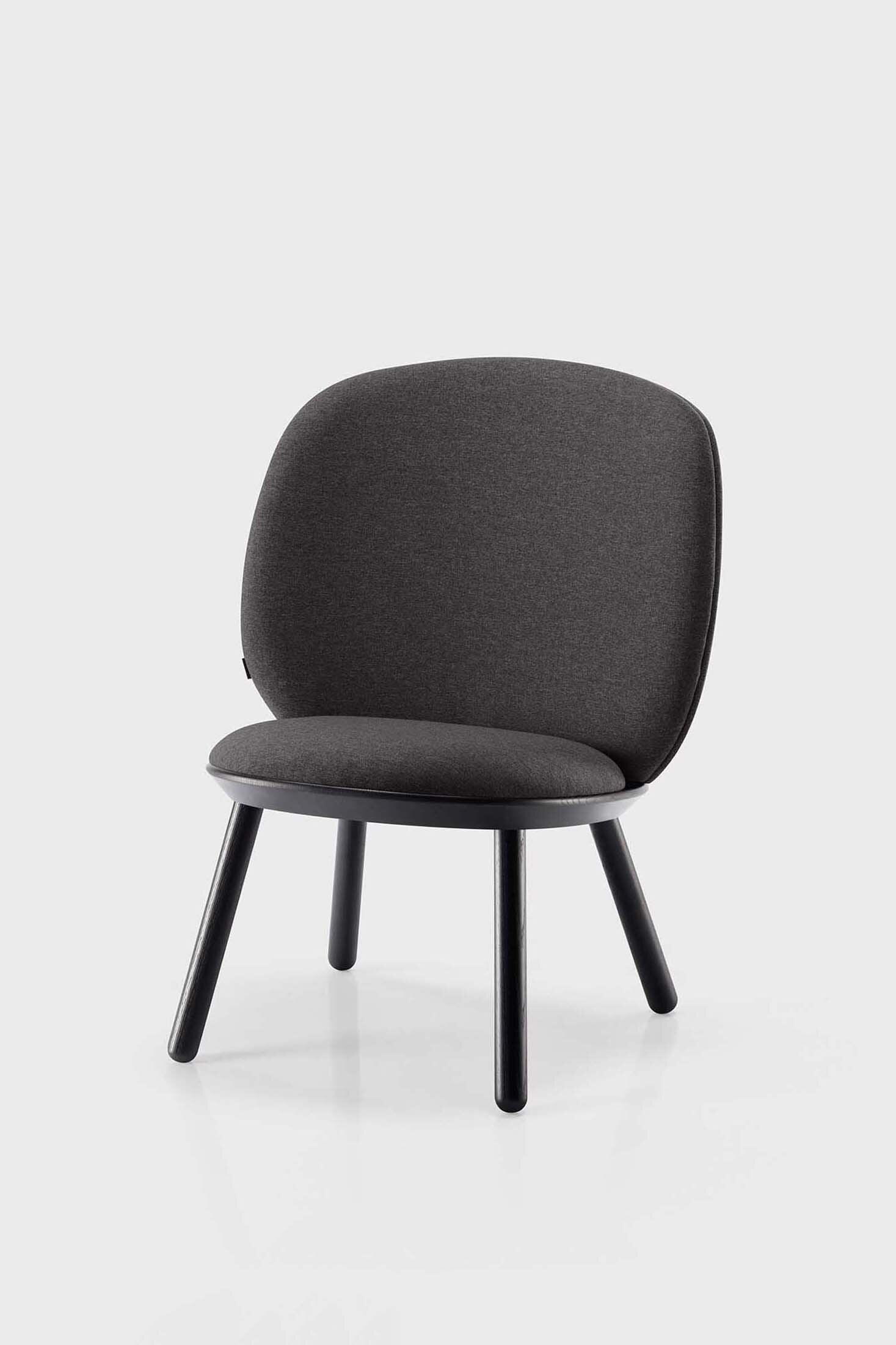 Naïve Low Chair featuring a large leather strap, wooden body, and textile upholstery, designed for comfort and style.