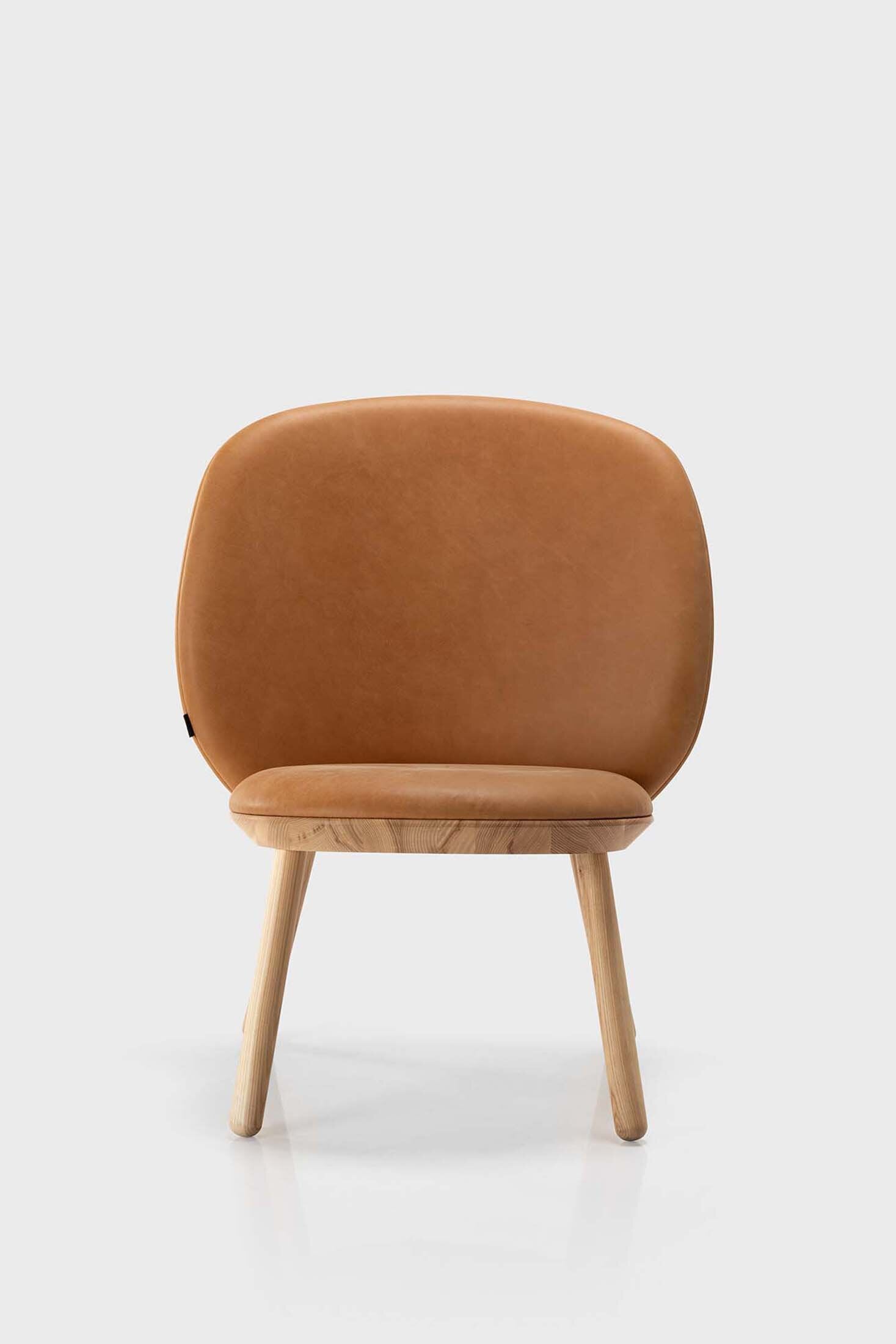 Naïve Low Chair featuring a large leather strap, wooden body, and textile upholstery, designed for comfort and style.