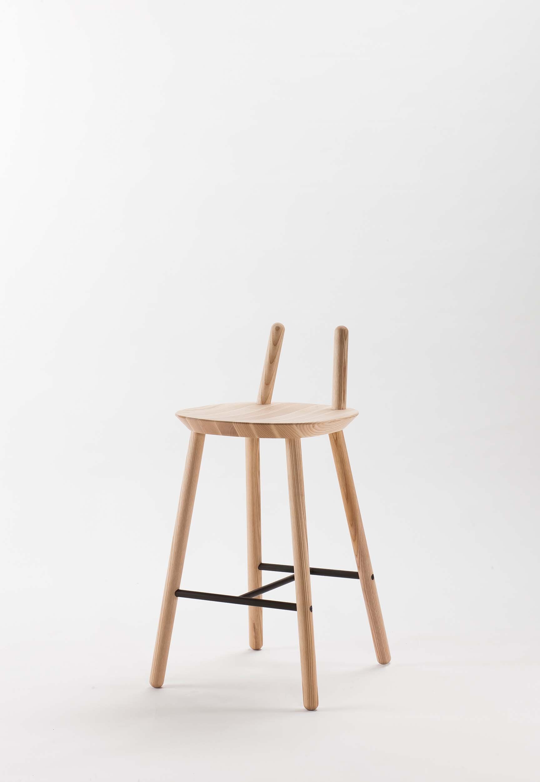 Naïve Semi Bar Stool featuring a carved seat and minimal backrest, with a durable steel footrest, ideal for home and public use.