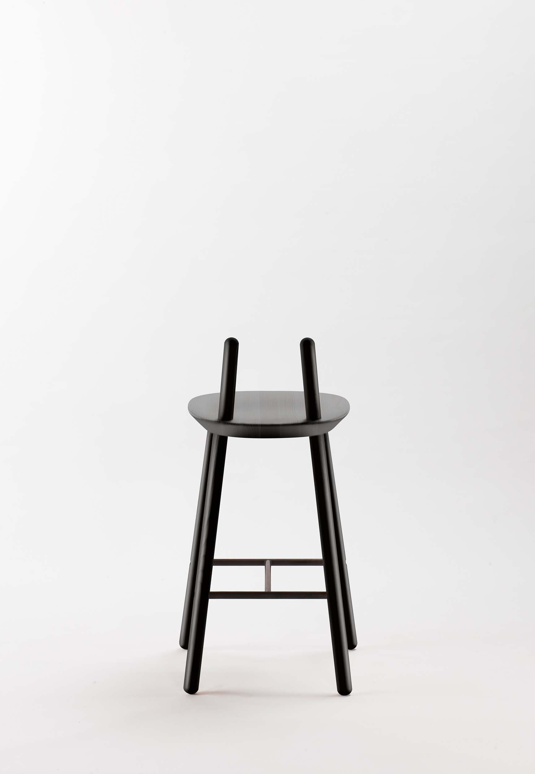 Naïve Semi Bar Stool featuring a carved seat and minimal backrest, with a durable steel footrest, ideal for home and public use.