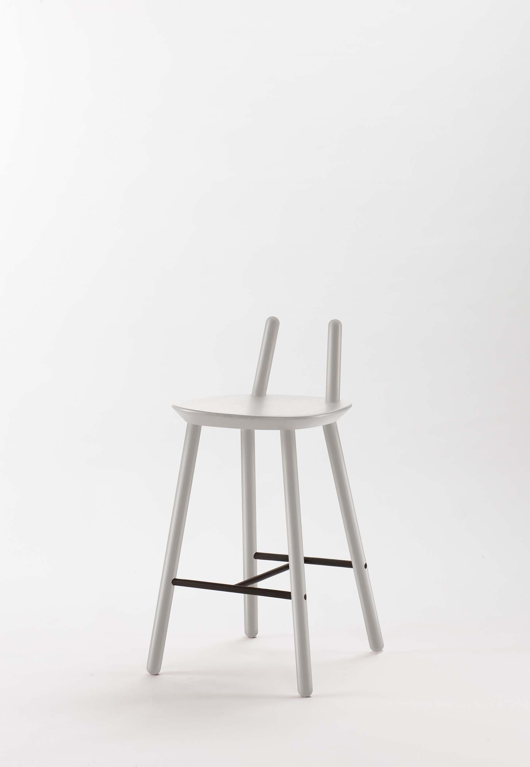 Naïve Semi Bar Stool featuring a carved seat and minimal backrest, with a durable steel footrest, ideal for home and public use.