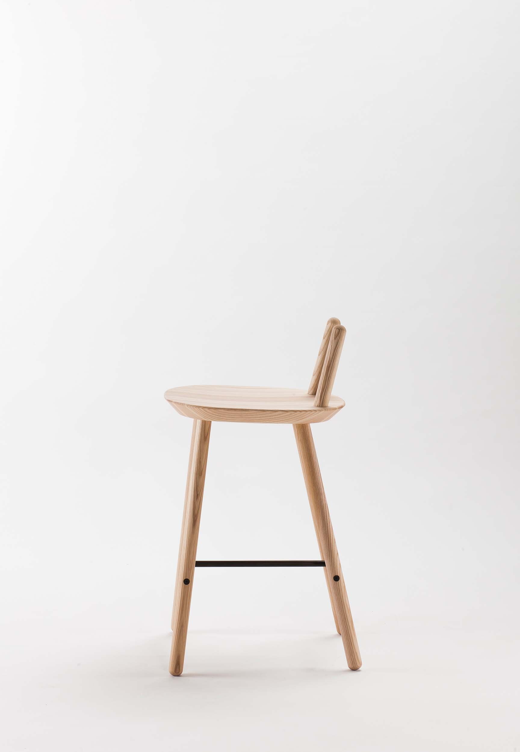 Naïve Semi Bar Stool featuring a carved seat and minimal backrest, with a durable steel footrest, ideal for home and public use.