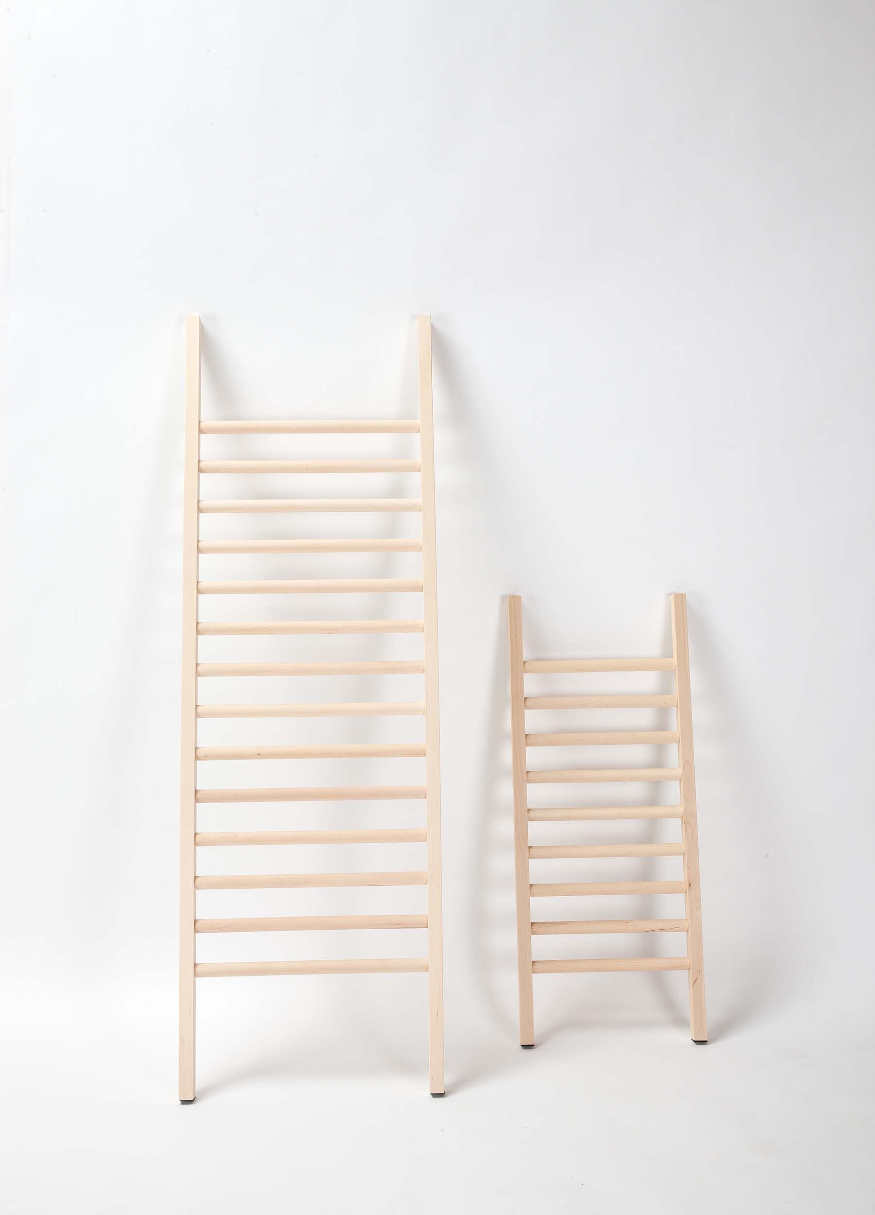 Step Up Shoe Rack by Tore Bleuzé, featuring a minimalist design for stylish shoe organization against a wall.