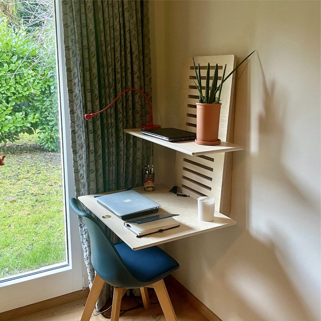 WallStand adjustable wall-mounted standing desk with two shelves, showcasing a sleek design and premium Baltic Birch plywood material.