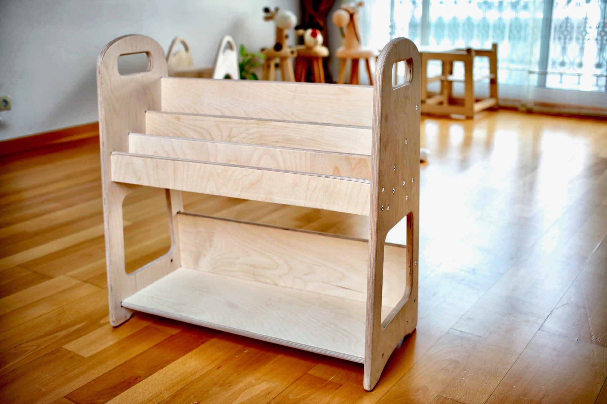 A large wooden bookshelf designed for children's rooms, featuring adjustable shelves and a natural wood finish, ideal for Montessori-style storage.