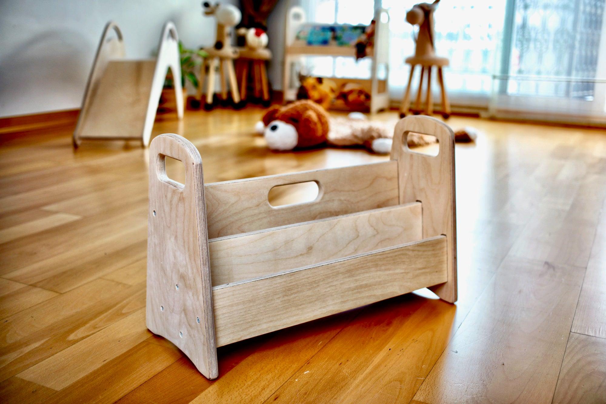 A colorful wooden bookshelf designed for children, featuring multiple shelves at a lower height for easy access to books.