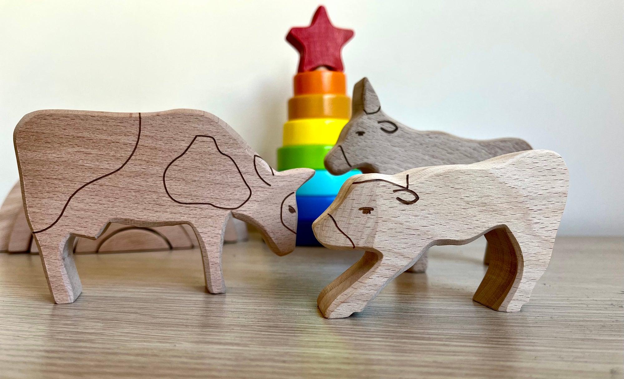 A colorful Wooden Farm Animals Set featuring intricately designed figures of cows, horses, pigs, ducks, and chickens, perfect for children's imaginative play.