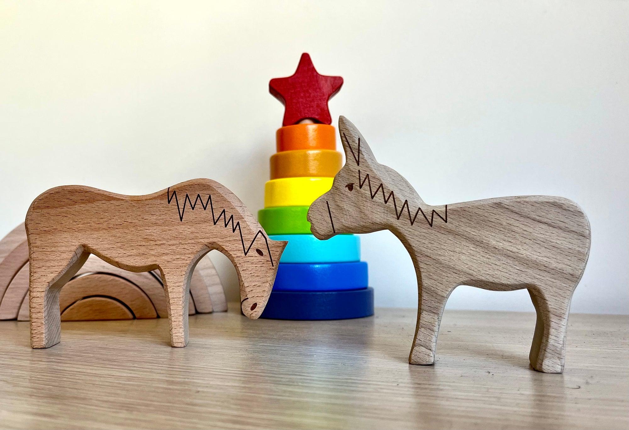 A colorful Wooden Farm Animals Set featuring intricately designed figures of cows, horses, pigs, ducks, and chickens, perfect for children's imaginative play.