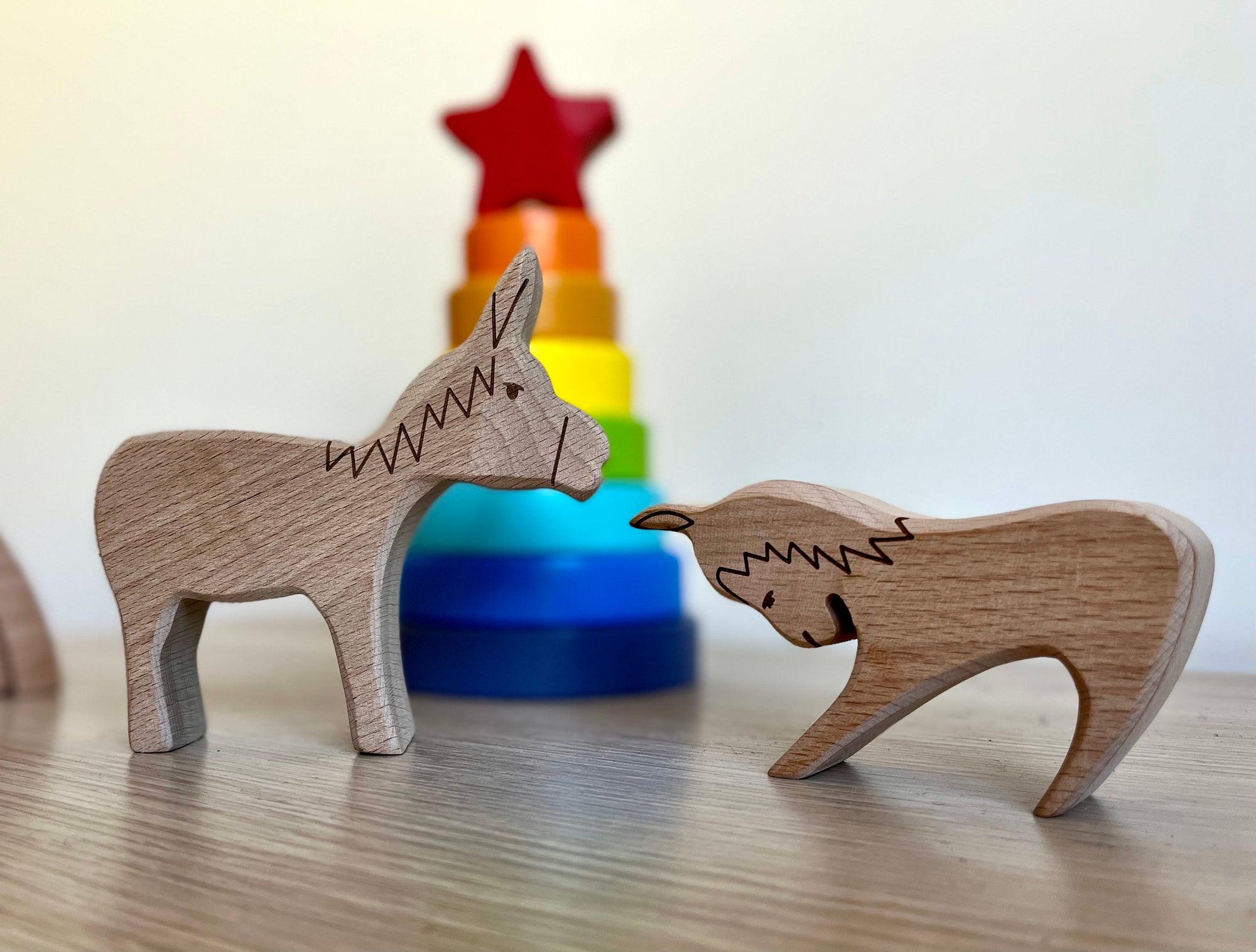 A colorful Wooden Farm Animals Set featuring intricately designed figures of cows, horses, pigs, ducks, and chickens, perfect for children's imaginative play.