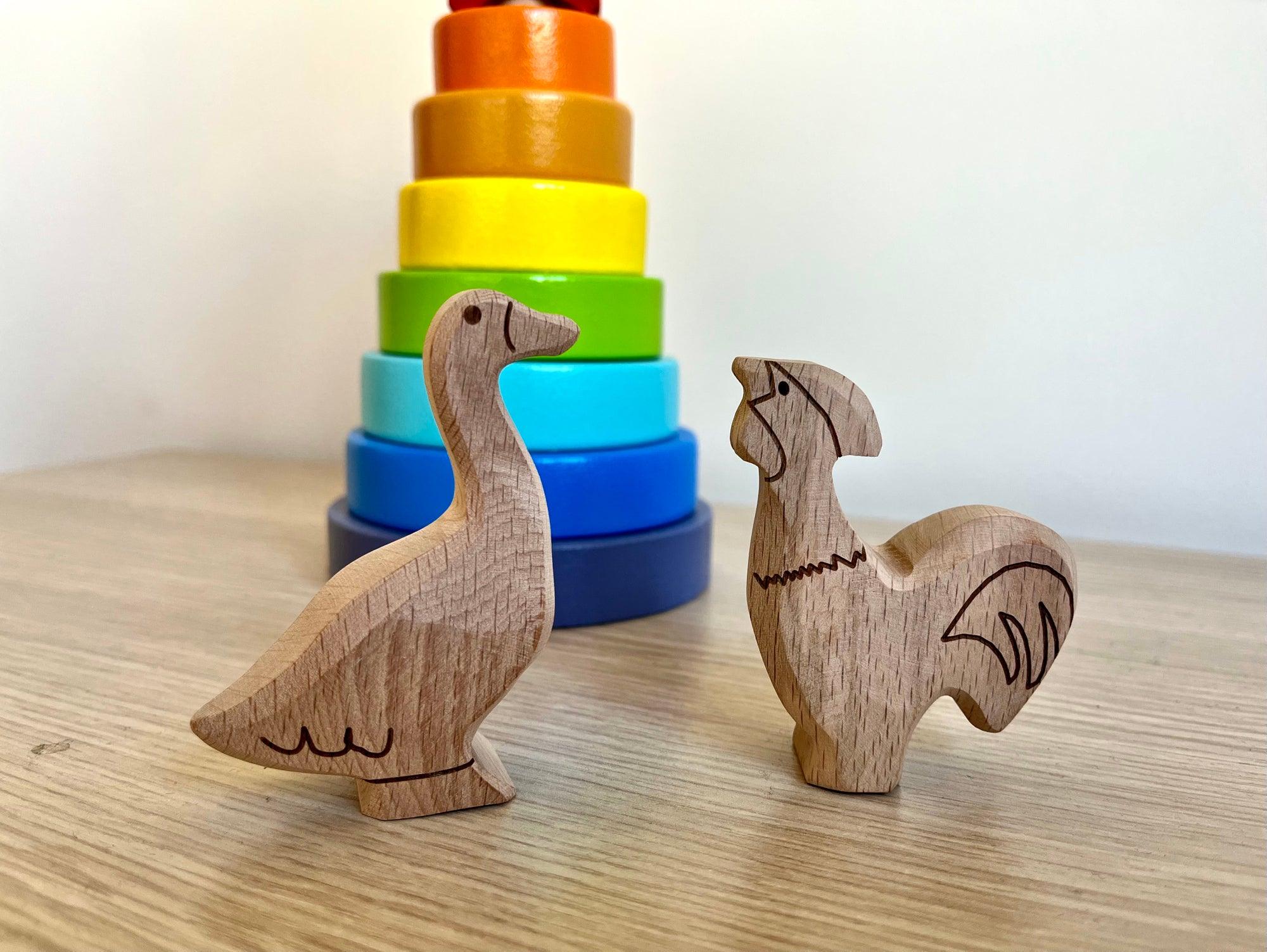 A colorful Wooden Farm Animals Set featuring intricately designed figures of cows, horses, pigs, ducks, and chickens, perfect for children's imaginative play.