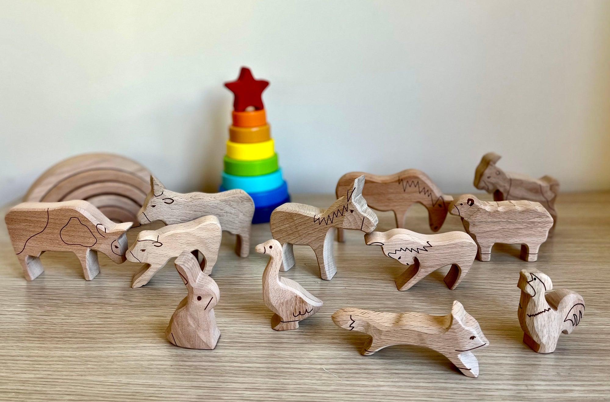 A colorful Wooden Farm Animals Set featuring intricately designed figures of cows, horses, pigs, ducks, and chickens, perfect for children's imaginative play.