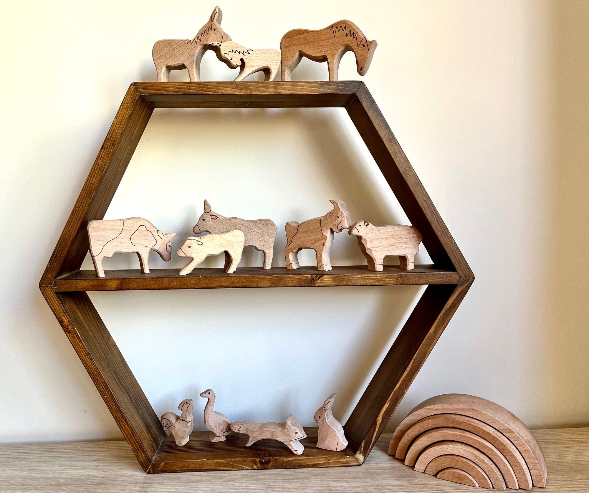 A colorful Wooden Farm Animals Set featuring intricately designed figures of cows, horses, pigs, ducks, and chickens, perfect for children's imaginative play.