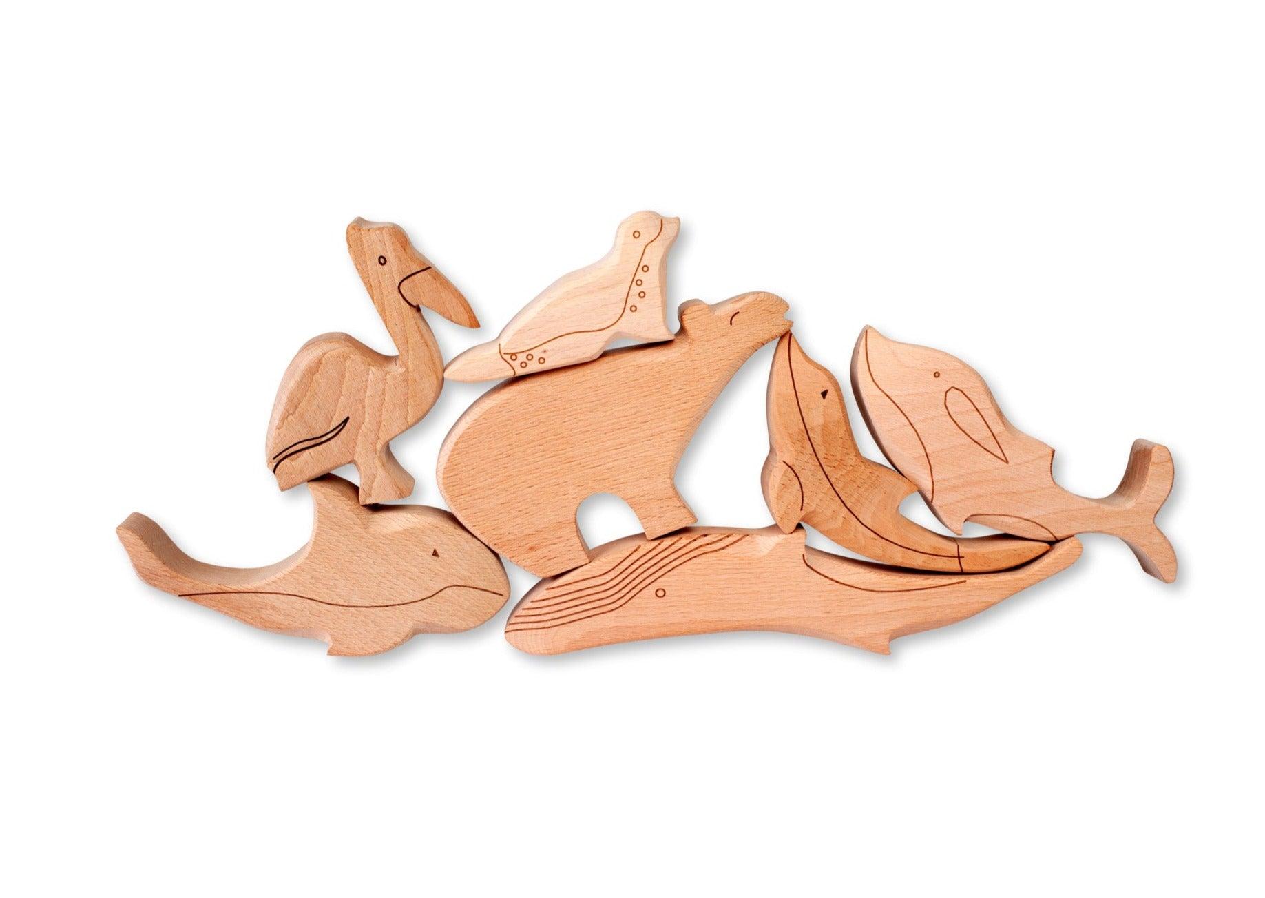 A colorful Wooden Ocean Animals Set featuring a dolphin, whale, sea turtle, starfish, and clownfish, designed for children's play and education.