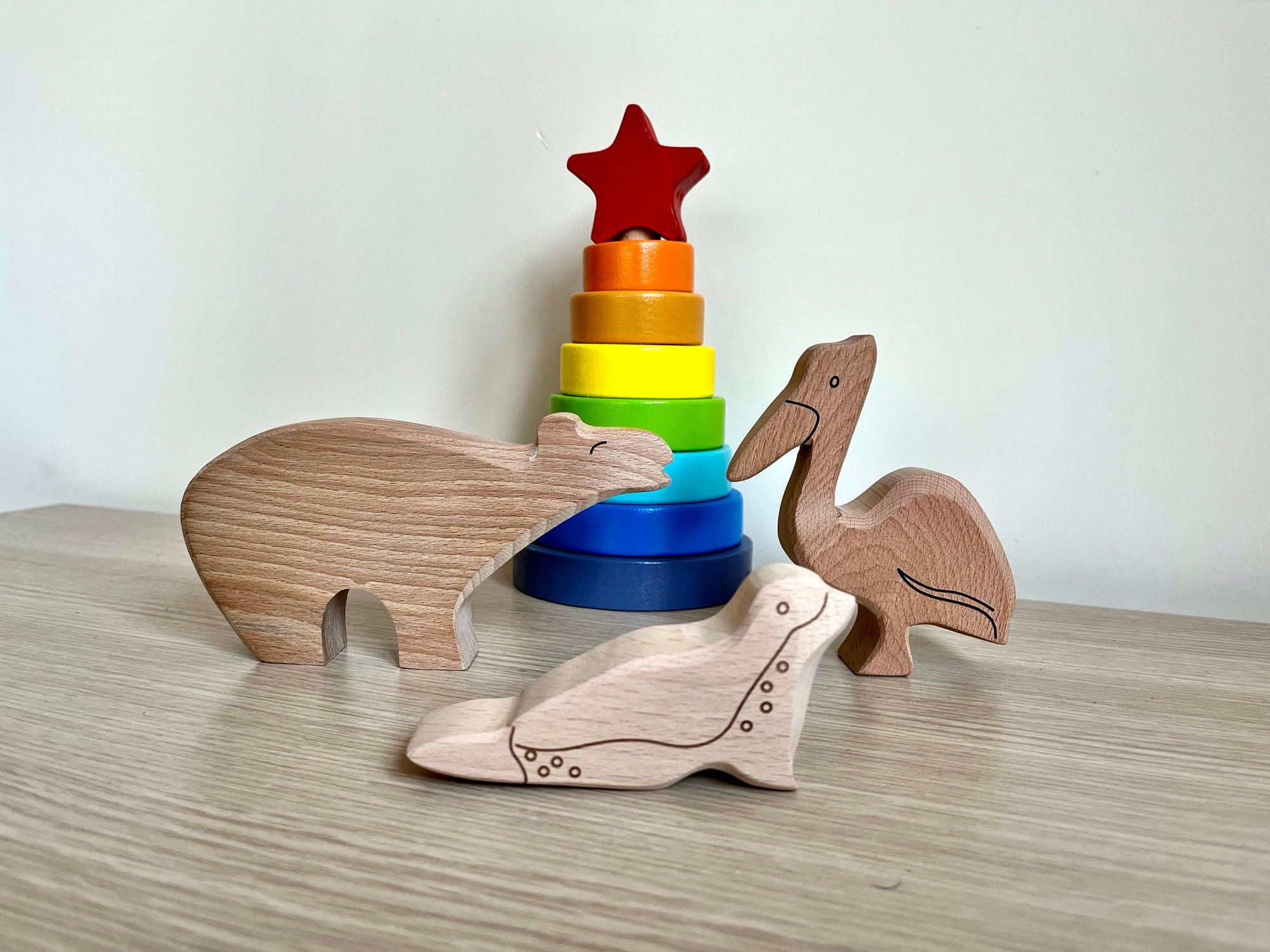 A colorful Wooden Ocean Animals Set featuring a dolphin, whale, sea turtle, starfish, and clownfish, designed for children's play and education.