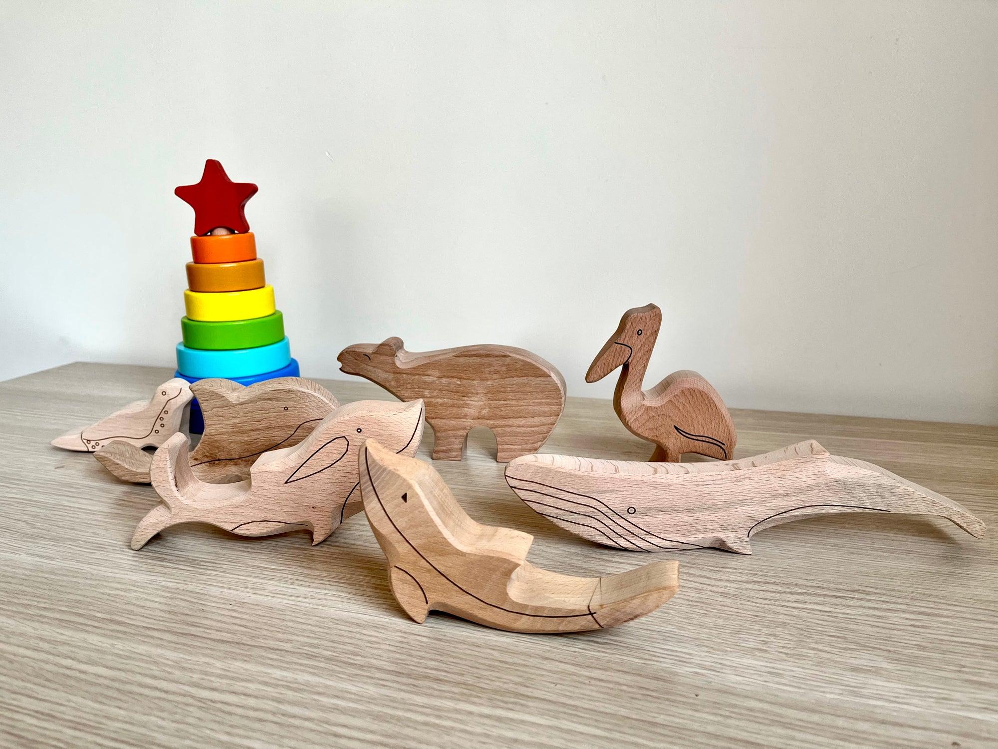 A colorful Wooden Ocean Animals Set featuring a dolphin, whale, sea turtle, starfish, and clownfish, designed for children's play and education.