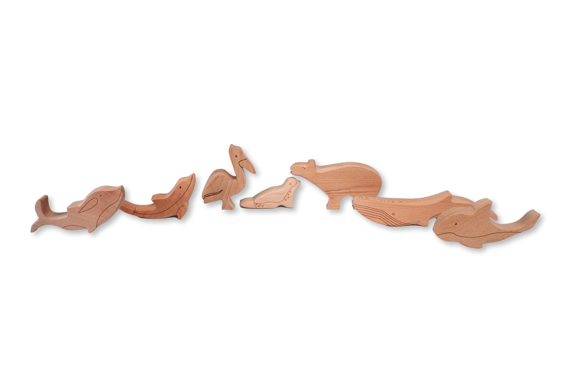 A colorful Wooden Ocean Animals Set featuring a dolphin, whale, sea turtle, starfish, and clownfish, designed for children's play and education.