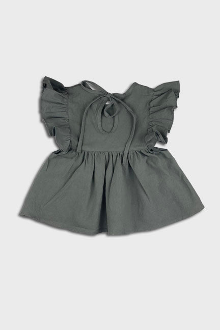 A stylish 2 pc set in vintage green featuring a flowing dress-like top with flutter sleeves and matching bloomer bottoms.